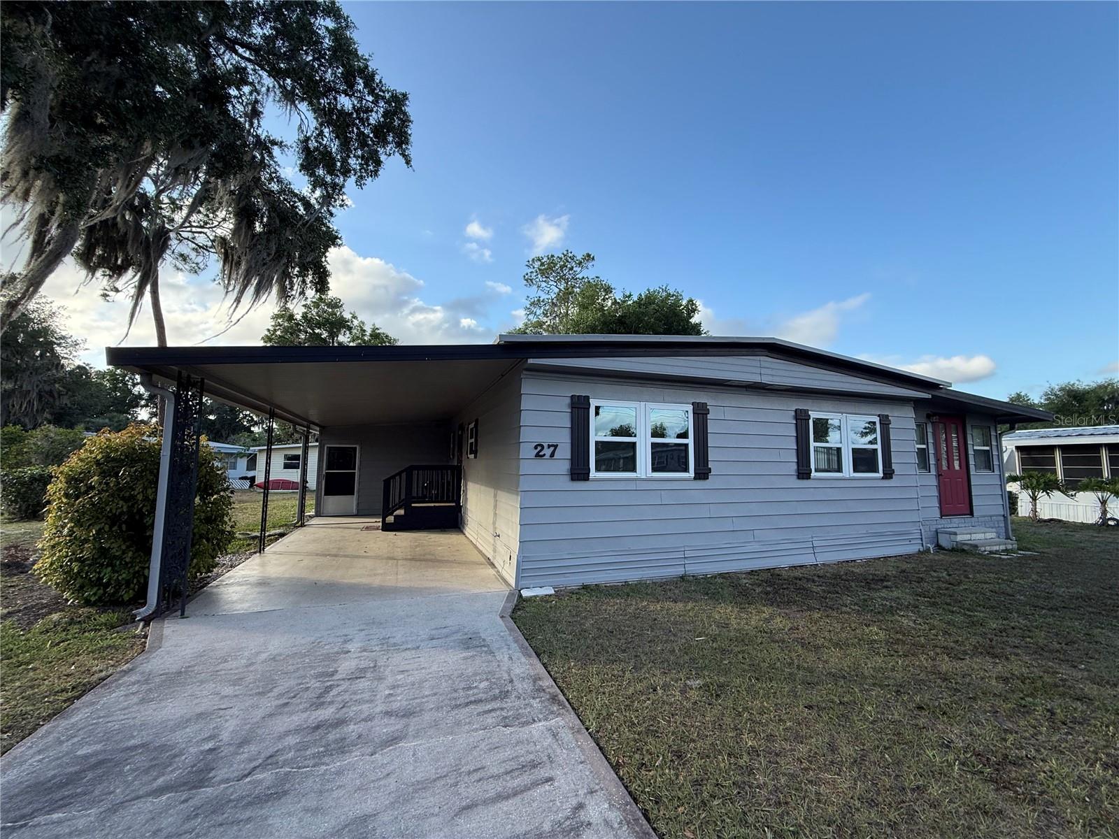 NEAR THE VILLAGES, FISHING, BIKING, TRAILS, ACTIVITIES, LIVE MUSIC, LOUNGE FUN, FRIENDSHIPS, SHOPPING AND SO MUCH MORE!!

This charming 2-bedroom, 2-bath home sits on a huge, oversized lot, offering plenty of outdoor space and the exciting potential to easily expand if desired. Inside, the home features new flooring and fresh paint throughout, creating a bright, clean, and welcoming feel. It comes furnished to start, making move-in simple and convenient. Both bathrooms are impressively large, and the entire home has been very well maintained. A spacious, lovely bonus room provides the perfect place for entertainment, hobbies, or quiet relaxation. The dining room includes a built-in hutch ideal for storing all your cooking and baking essentials, while the open living room flows into a comfortable kitchen with great counter space and plenty of cabinets. The spare bedroom and guest bath are very nice, with the bath offering a full-size tub. The primary suite is open, roomy, and inviting, giving you a peaceful retreat. With new windows throughout, this home feels refreshed and ready for its next owner. Sitting on such a generous lot and in such great shape, this is truly a must-see—call your agent now and come take a look.