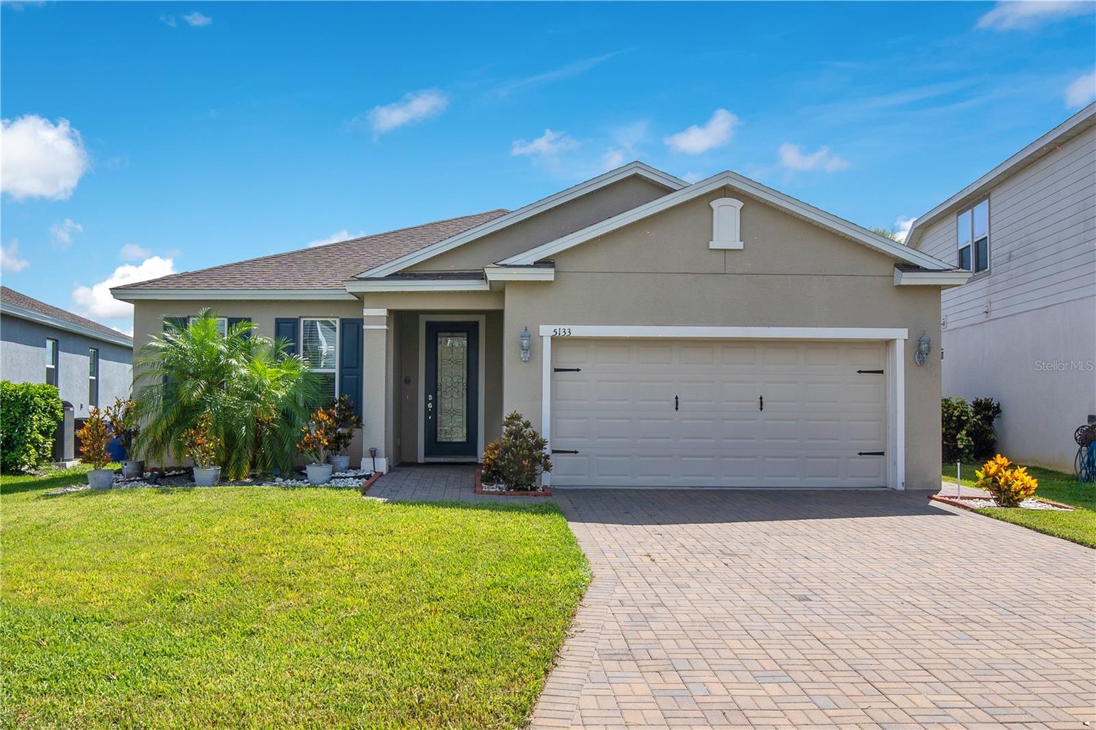 Experience the perfect blend of style, comfort, and waterfront living in this beautifully maintained 4-bedroom, 3-bathroom home located in the highly sought-after Live Oak Lake community. Perfectly positioned on a premium pond-front homesite, this home offers peaceful water views, an open-concept design, and a thoughtfully designed layout ideal for everyday living and entertaining.

Step inside to discover a bright and spacious living area featuring elegant tray ceilings, abundant natural light, and seamless flow into the heart of the home. The gourmet kitchen is designed to impress with granite countertops, stainless steel appliances, rich wood cabinetry, a stylish tile backsplash, a large center island with bar seating, and a generous dining area—making it the perfect space for gathering with family and friends.

Designed with flexibility in mind, this home features two private primary suites, making it ideal for multigenerational living, extended guests, or anyone seeking additional privacy. The main primary suite serves as a relaxing retreat complete with tranquil pond views, a spacious walk-in closet, and a luxurious en-suite bathroom featuring dual vanities and a large walk-in shower. The second suite offers its own private full bath, creating a comfortable space for family or visitors.

Step outside to your backyard oasis where you'll enjoy uninterrupted pond views and plenty of space to relax, grill, or entertain while taking in the peaceful waterfront setting. Whether you're enjoying your morning coffee on the patio or winding down after a long day, the serene backdrop makes every moment feel like a retreat.

Located in the amenity-rich Live Oak Lake community, residents enjoy convenient access to parks, walking trails, playgrounds, and are just minutes from Lake Nona, Medical City, the Florida Turnpike, Orlando International Airport, shopping, dining, and top-rated schools.

Offering a rare combination of dual primary suites, beautiful water views, and a prime location, this exceptional home is ready to welcome its next owners.