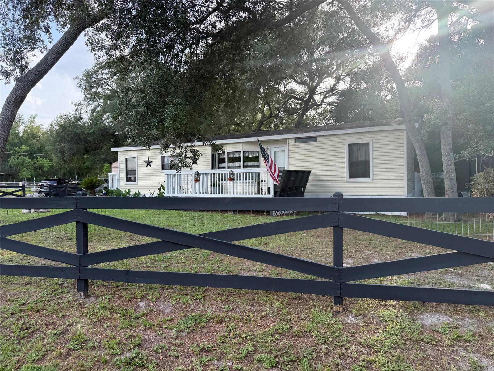 Welcome Home to this Country Charming 3 Bedroom 2 Bathroom 2 Car Carport Fully Fenced In Yard & Back Yard Separately Fenced. Original
Owner of a very well maintained home and property. All good workmanship has went into this home with all new siding on the exterior of this home and the inside has been totally remodeled with many upgrades like Granite Countertops & All Real Wood Cabinets. Clean Ceramic Tile Floors & Wood Plank Luxury Vinyl Flooring in Great Condition. Newer Appliances included as this House is Move in Ready on an Oversized Corner Lot which is 1/4 of an Acre Fully Fenced including a 28 x 17 Covered 2 Car Carport. Perfect Yard for multiple animals with two separate fenced in areas of the yard. Relax on the Huge Wood Front Deck Porch and watch the Sunrise or Enjoy your back yard which has 2 Workshops/Storage Buildings and Patios and Pavers throughout the property including a huge bird bath that conveys with the sale. Mature Shaded Landscaped setting with a park like setting throughout the yard with huge firepit in the back yard. Water is from a deep submersible well with good drinking water and house is on a private septic system. Call today to schedule an appointment to show as need a notice before showing appointments