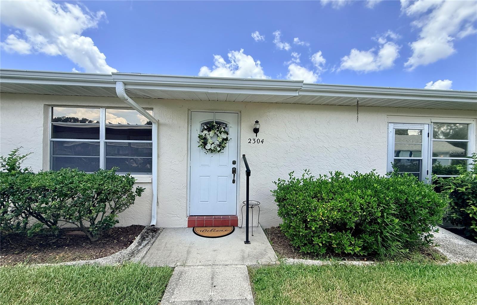 Welcome to the highly sought-after, golf cart-friendly 55+ gated community of Kings Point! This desirable end-unit condo located on a peaceful roundabout with courtyards views. *** Enjoy true maintenance-free living with condo fees that include cable, water, sewer, trash, pest control, lawn care, roof repair/replacement, and access to an incredible array of resort-style amenities. Residents enjoy over 200 clubs and activities, multiple indoor and outdoor heated pools, fitness centers, pickleball, on-site salons, two restaurants, and so much more — all without ever needing to leave the community! *** A covered carport is located just steps from the front door. *** The popular Glenmore floor plan is a well maintained home offering 2 bedrooms, 2 bathrooms, and a bright Florida Room perfect for relaxing and enjoying the views. The spacious living and dining areas create an open layout ideal for both everyday living and entertaining. *** The kitchen features abundant cabinetry, generous counter space, and a dishwasher for added convenience. The dishwasher, microwave, washer and dryer are brand new and never been used. The large primary suite easily accommodates king-size furnishings and includes a full wall of closets along with a private en-suite bath. With a large interior laundry room, water softener system, with storage and everyday functionality. *** Association allows 30-day minimum rentals, offering excellent flexibility for seasonal or investment opportunities. Residents of Kings Point enjoy access to two clubhouses featuring resort-style amenities, including lap pools, aerobic pools, expansive gathering decks, cookout spaces, social events, and endless opportunities to stay active and connected. ***Some photos are AI to show the possibilities of tranquil retirement home.