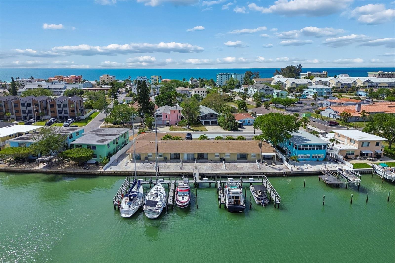 Exceptional opportunity to own a fully renovated waterfront apartment complex in highly sought-after Indian Rocks Beach. Situated on three contiguous lots, this unique property features eight well-appointed units and six deepwater boat slips, creating multiple income streams and offering both immediate revenue potential and long-term upside. Recently renovated in 2026, the property offers a well-balanced unit mix with five 2-bedroom, 1.5-bath units and three 1-bedroom, 1-bath units, appealing to a wide range of renters. Six units—including four 2-bedroom and one 1-bedroom—enjoy beautiful water views with sliding glass doors opening to covered porches and shared outdoor spaces overlooking the bay, while two additional 1-bedroom units are located in a detached front duplex.

The property is comprised of three separate buildings arranged around a charming palm-lined courtyard. The waterfront building includes the majority of the units with direct water views and access, while a third structure provides six covered carports, eight private storage rooms, a common laundry facility, and an EV charging station. Boating enthusiasts will appreciate the on-site marina with six deepwater slips accommodating vessels up to 50 feet, complete with electric (110V/220V), water hookups, and individual dock boxes, with projected boat slip income of approximately $45,000 annually. With approximately 160 feet of water frontage, this property delivers true coastal living.

Previously operated as an annual rental, the property presents significant upside through conversion to short-term rentals, as Indian Rocks Beach allows for short-term leasing—making it an ideal opportunity for investors looking to maximize returns or reposition as a boutique hotel or motel concept. Additional highlights include ample guest parking and walkability to the beach, enhancing both tenant and guest appeal. STR AirDNA reports available upon request. 

With recent renovations complete, multiple revenue streams, and a prime waterfront location, this is a rare chance to acquire a high-performing, high-upside asset in one of Florida’s most desirable coastal markets. Seller financing available—contact for details.