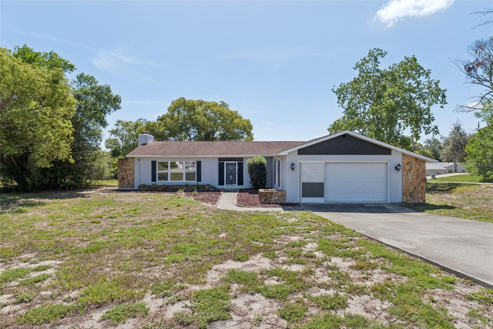 Investor Alert! Rare opportunity to renovate in an established neighborhood of well-maintained homes on spacious lots. Whether you're looking for your next fix-and-flip, rental investment, or a home to customize, this REO offers exceptional potential in a location that's hard to beat. Featuring a spacious living room with vaulted ceilings and a beautiful wood-burning fireplace, the current two-bedroom floor plan offers the potential for an easy conversion to three bedrooms, creating even greater value. An enclosed former lanai (not permitted) provides additional flex space, plus there's a separate 12' x 9' screened lanai under roof. Situated on a generous one-third acre lot, this home needs updating but is priced to reflect the renovations needed and offers an excellent opportunity to build equity. Conveniently located just minutes from Deltona Elementary, Fox Chapel Middle School, Oak Hill Hospital, shopping, dining, Hernando Beach, and Pine Island. Bring your vision and unlock the possibilities!