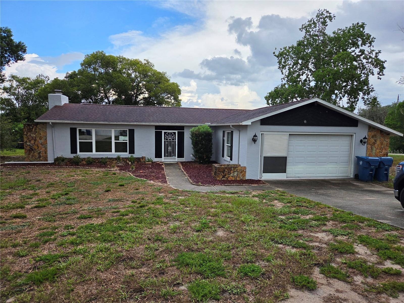 Investor Alert! Rare opportunity to renovate in an established neighborhood of well-maintained homes on spacious lots. Whether you're looking for your next fix-and-flip, rental investment, or a home to customize, this REO offers exceptional potential in a location that's hard to beat. Featuring a spacious living room with vaulted ceilings and a beautiful wood-burning fireplace, the current two-bedroom floor plan offers the potential for an easy conversion to three bedrooms, creating even greater value. An enclosed former lanai (not permitted) provides additional flex space, plus there's a separate 12' x 9' screened lanai under roof. Situated on a generous one-third acre lot, this home needs updating but is priced to reflect the renovations needed and offers an excellent opportunity to build equity. Conveniently located just minutes from Deltona Elementary, Fox Chapel Middle School, Oak Hill Hospital, shopping, dining, Hernando Beach, and Pine Island. Bring your vision and unlock the possibilities!