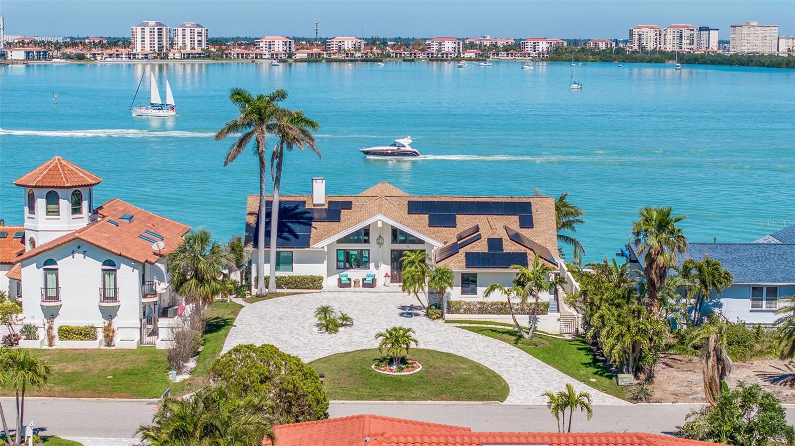 Luxurious and easy living in a STUNNING WATERFRONT RETREAT awaits you on the ISLAND PARADISE OF TIERRA VERDE. 
Upon entering this BEAUTIFULLY UPDATED, ONE-LEVEL CONTEMPORARY RESIDENCE, you will be mesmerized by the wall of floor-to-ceiling windows that bring the sparkling aqua waters of Boca Ciega Bay right into the room. Relax and enjoy the spectacular view as boats cruise slowly by in the channel’s no-wake zone, and be entertained as dolphins fish, frolic and play just a short distance away from the recently constructed dock and 85-ft seawall. The spacious, open concept Great Room with a vaulted volume ceiling is a major WOW-FACTOR, OFFERING WIDE-ANGLE VIEWS TO THE COASTAL OUTDOORS and endless opportunities for entertaining family and friends. Adjacent to the Great Room is a sleek and stylish kitchen, with Shaker soft-close cabinets, an induction range, convection oven and microwave, French Door stainless refrigerator and wine fridge. Soft gray veined Calacatta quartz countertops are complemented by a sea pearl mosaic backsplash, extending over a peninsula that provides ample seating for guests as well as extra storage space. A walk-in pantry provides additional storage space with built-in shelves and cabinetry.

Combining an elegant living space that blends outdoor and indoor living with one of the most elevated waterfront lots on the island, you can rest assured that you are high and dry. NEW PGT hurricane-impact windows, sliders and doors and a fully-owned solar heating and cooling system keeps electric bills at $30/month, and gives you added peace of mind. Other upgrades in include a 3-ton variable speed heat pump/return from main area, a new pool pump and a retractable solar pool cover.

The split floor plan features a primary retreat with a volume ceiling, loft storage area, and sliders leading out to an elevated private patio looking across to the Tierra Verde bridge, where you can greet the inspiring daily sunrises with your morning cup of coffee. The primary bath has a spa-like ambiance with porcelain tile, elegant, modern floating sinks, and a super shower with a double rain head shower system and built-in bench. Two other bedrooms on the opposite side of the home, one with a Murphy Bed, provide a separate private guest wing, with a shared modern updated bath, tub and shower.

Outside, enjoy the coastal breezes and wide-water views from an expansive 2-level patio, or while taking a dip in the solar-heated pool and spa. A newly constructed outdoor grilling nook lets you dine outdoors into the evening as the sun sets over the famous Don CeSar Hotel to the west. Boaters can cruise east through the Pinellas Bayway Tierra Verde Bridge to Tampa Bay … and to the west with direct unobstructed access via Pass-a-Grille Channel out to the Gulf.

The island paradise of Tiera Verde is just off the beaten path from the local tourist scene, but with easy access to everywhere! It’s only  30-40 MINUTES FROM 2 INTERNATIONAL AIRPORTS VIA I-275 and 10 minutes to downtown St. Pete with its cultural attractions, entertainment venues, Saturday Morning Market and top-rated restaurants. Best of all, you are within minutes of the area’s sought-after Gulf beaches and award-winning Fort DeSoto, an 1100 acre park offering an array of sugar sand beaches, boat launches, fishing, camping, kayaking and miles of nature trails – all right in your backyard. Don’t miss the opportunity to schedule your showing today to tour this COASTAL DREAMHOUSE!