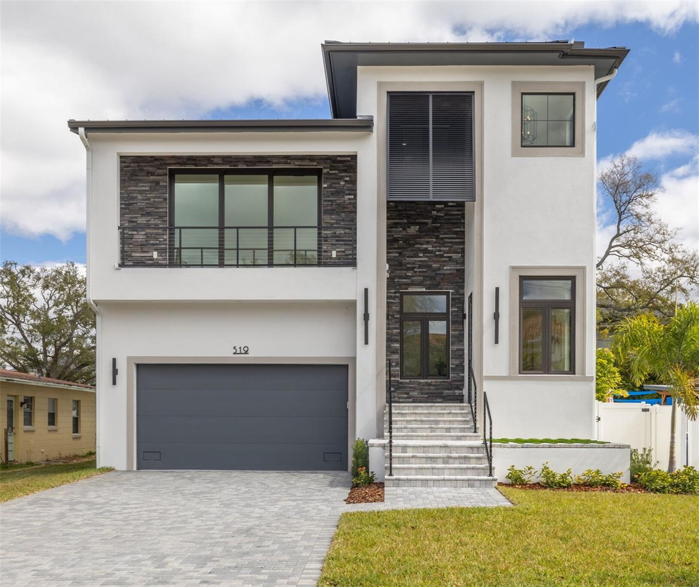 Just awarded the "2026 Parade of Homes Grand Custom Winner".  Thoughtfully crafted residents with a refined transitional coastal aesthetic, this newly completed luxury residence offers 3,828 square feet of beautifully curated living in the heart of Davis Islands. Designed for effortless entertaining and private retreat alike, the home blends architectural presence, outdoor living, and elevated finishes throughout.

Natural light pours through oversized casement windows, highlighting 12-foot ceilings and wide-plank white oak flooring that enhance the openness and airy feel of the first-floor layout. The open-concept great room flows seamlessly to the outdoor living areas, creating volume while maintaining warmth and livability. A private first-floor office with glass sliding doors, a convenient half bath, and a guest suite with en-suite bath provide flexibility and privacy for both daily life and visiting guests.

The gourmet kitchen pairs crisp white custom cabinetry with a seafoam-accented island, quartz countertops, and elegant gold hardware for a refined yet inviting design. The oversized island offers generous prep space, storage, and casual dining, making it the natural centerpiece of the home. A Thermador appliance suite includes a 48-inch gas range with griddle, dual 30-inch ovens, 48-inch French door refrigerator/freezer, stainless hood, under-counter microwave and complemented by a Bosch dishwasher. The adjacent dining area features a built-in dry bar with glass reflective backsplash, display shelving, under-counter storage, and wine and beverage refrigeration—perfect for entertaining.

Behind a shiplap-designed Murphy door, a private mid-level bonus retreat with balcony and half bath provides versatile space for a lounge, office, or guest overflow.

Upstairs, 10-foot ceilings frame a luxurious primary suite with two walk-in closets and a spa-inspired bath featuring a freestanding soaking tub, quartz vanity, and oversized walk-in shower with rain head and frameless glass enclosure. A separate dry bar with beverage refrigerator—pre-plumbed for a coffee maker—opens to a private balcony, creating a peaceful escape within the suite. Three additional bedrooms each include their own full bath with designer tile finishes.

Outdoor living is private and intentional. The fully screened covered lanai with stacked stone accent wall overlooks a courtyard-style backyard designed for relaxation and entertaining. A sun-shelf pool with water features creates a tranquil focal point, while the upper-level covered porch includes an outdoor kitchen with beverage refrigerator and is prewired for television.

Additional features include impact windows and doors, 12-foot elevation, standing seam metal roof, tankless gas water heater, and prewiring for a 26KW gas generator.

Located on Davis Islands, this home offers an unparalleled lifestyle in a vibrant, walkable community favored by professional athletes, executives, and families alike. The neighborhood is home to a wealth of amenities, including Marjory Park Marina, the Sandra Freedman Tennis Complex, the historic Roy Jenkins pool, and Peter O. Knight Airport. A short stroll brings you to the Davis Islands Village, where you’ll find a variety of restaurants and shops. With its prime location just minutes from Downtown Tampa, Water Street, Sparkman Wharf, and the Tampa Riverwalk, this home truly offers the best of both island living and urban convenience.