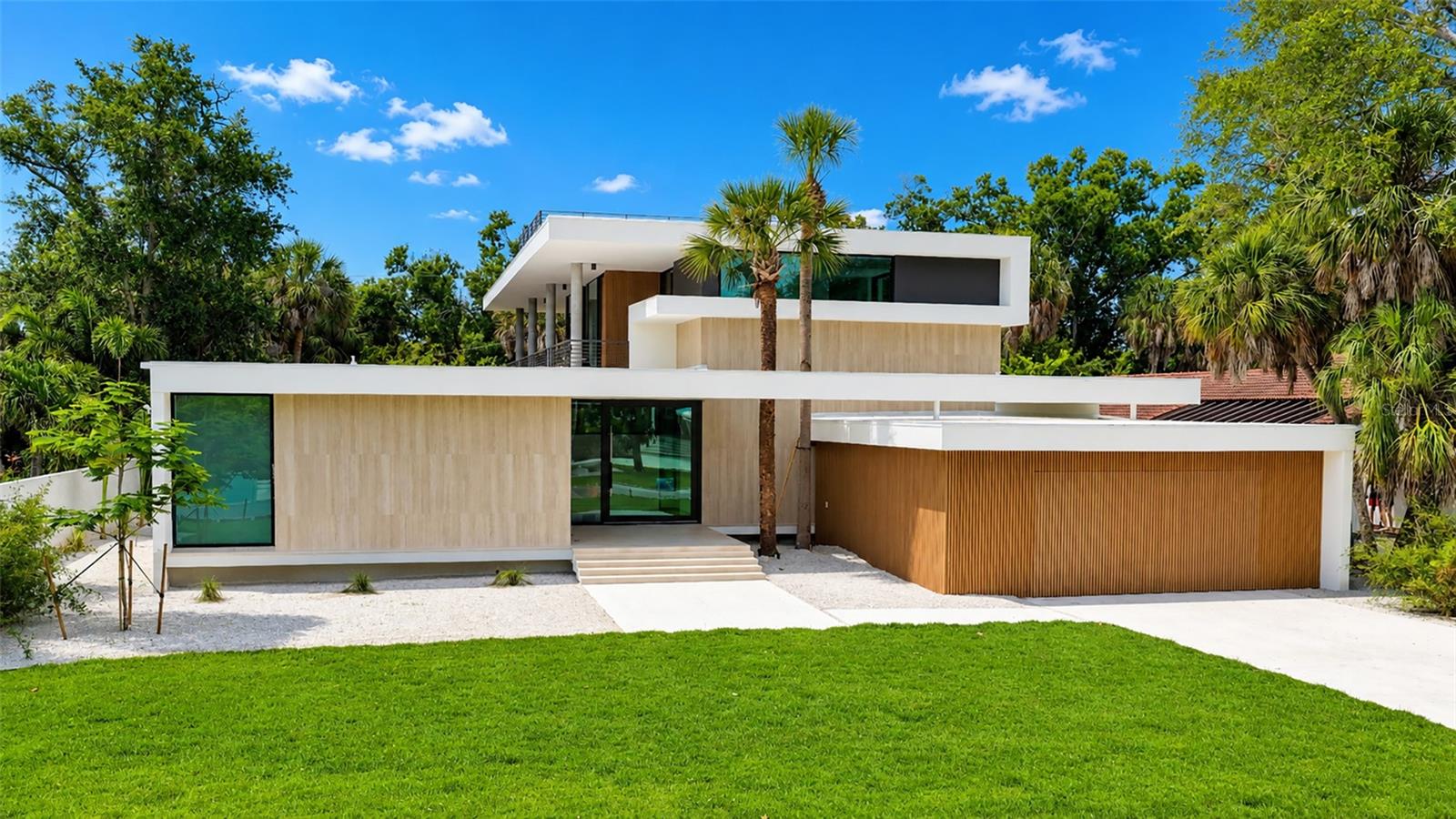 Virtually Staged. JUST COMPLETED - READY TO MOVE-IN! What a rare opportunity to own a stunning brand new, "State of the Art" home just next to a historic landmark, the Ringling Museum, which defines Sarasota's culture. Built by Seaward Homes, this residence is in the final stage of completion but still offers enough time to add your own ideas or touches, before occupancy. Enjoy the ultimate Sarasota lifestyle in the Museum Area. Designed by Lear Studio Architecture, this home epitomizes exceptional quality and attention to details. This domicile offers 4 en-suite bedrooms, and almost 4,000 sq ft of air-conditioned living space, including a multipurpose room that can be tailored for wellness, fitness, or a variety of additional lifestyle needs. The wide-open floor plan, generous room sizes, and large impact-rated safety glass sliding doors and windows fill the home with natural light. Terraces on the main and second floors provide ideal spaces to enjoy the outdoor lifestyle, plus a spacious rooftop terrace for great sunset views. The interior finishes include European oak wood flooring, fine cabinetry with quartz countertops, a custom floating steel-and-wood staircase, three high-efficiency mechanical systems, a top-of-the-line appliance package. Exterior features include solid concrete and masonry construction on the first floor, and premium architectural facade details with Travertine porcelain wall cladding. The resort-like pool area and custom spa are surrounded by a lush tropical landscape package. Downtown Sarasota and the Sarasota/Bradenton International Airport are just a few minutes away. Embrace the opportunity to own this unparalleled residence and experience luxury Florida living.