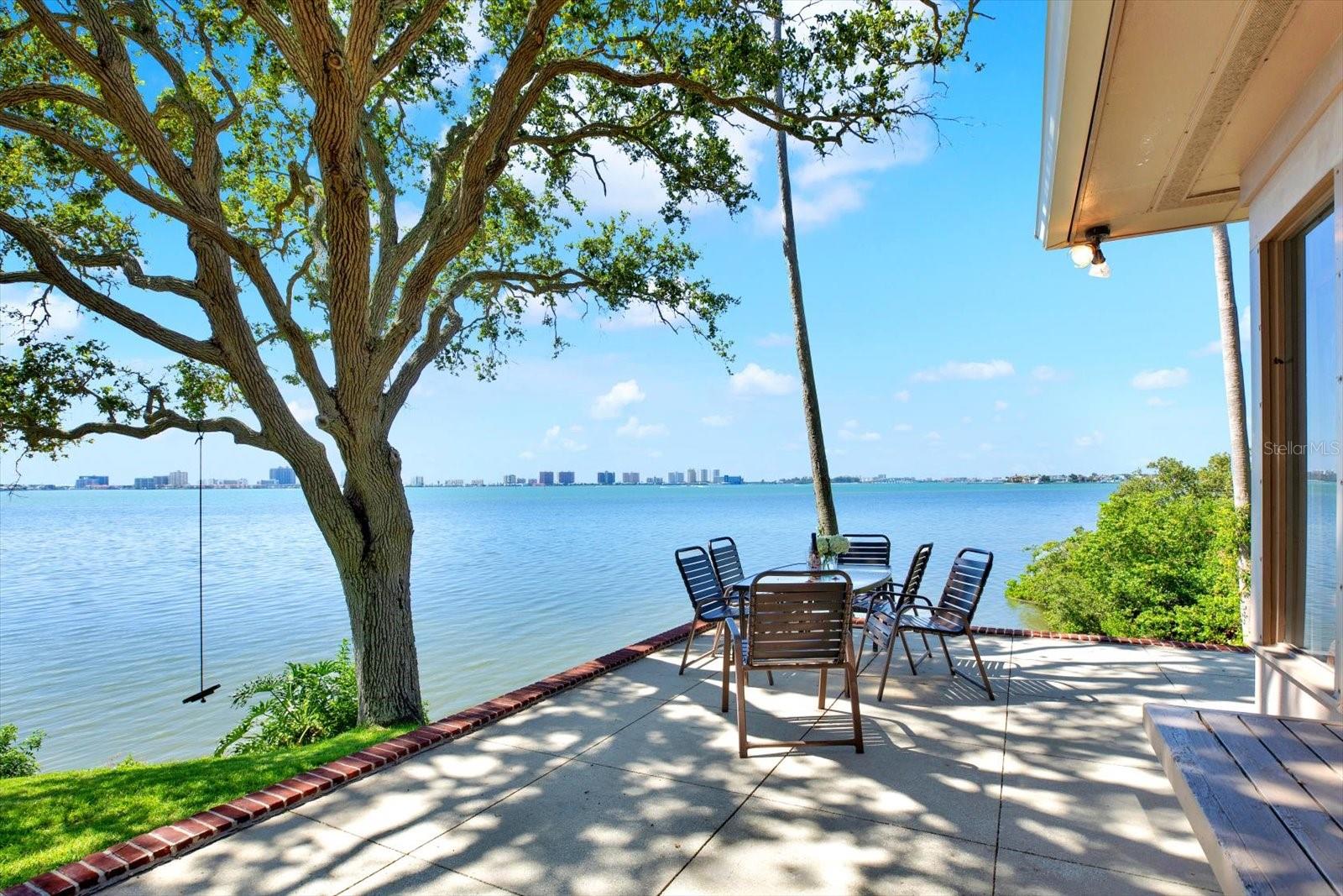 Bay-Front Home in Belleair on Rare Coastal Bluff – Waterfront views extending to
Florida’s Gulf Coast!

One of a handful of homes nestled on a private gate-able drive offering extraordinary
privacy, this classic one-story waterfront beauty sits 14 feet atop a natural bluff
overlooking Clearwater Bay. Waterfront - no flooding in 40-years ownership! Abundant
windows frame mature trees and fill the home with natural light. Breath-taking views
bring outdoors in, a seamless connection to surrounding natural beauty. Nearly 3000
SF, concrete construction, three bedrooms, three full and one half-bath, storage galore,
living room with beautiful natural fireplace, huge dining room. Bright and spacious
open-concept home perfect for entertaining. Air-conditioned terrazzo sunroom opens to
patio deck with unique water views you must see to believe. Perfect for relaxing or
entertaining, cooled by bay breezes, enjoying panoramic water views, stunning sunsets
and entertaining wildlife...dolphins, otters, eagles and more. 720 SF basement(so rare
in Florida!) with endless possibilities; playroom, gym, storage, man cave, etc. Riparian
rights ensure continued enjoyment of a myriad of water activities from your own
backyard including kayaking, fishing, paddleboarding and more, perhaps your own
dock! Bordered to the south by green space and to the north by more than five acres of
water-front park land, this property provides a rare level of privacy and seclusion. Enjoy
peaceful walks along the water, surrounded by a symphony of bird songs beneath a
canopy of majestic oaks. Belleair offers a small-town atmosphere with sophisticated
conveniences … quality restaurants and shopping, town recreation center and
prestigious Pelican and Belleair Country Club are within two miles, and Florida’s stunning Gulf Coast beaches are just minutes away. Belleair’s long history, civic pride
and year-round community events make it one of Tampa Bays most sought-after
neighborhoods. All this and just thirty minutes from TPA.

Don’t miss this opportunity to own an incredibly unique piece of paradise.