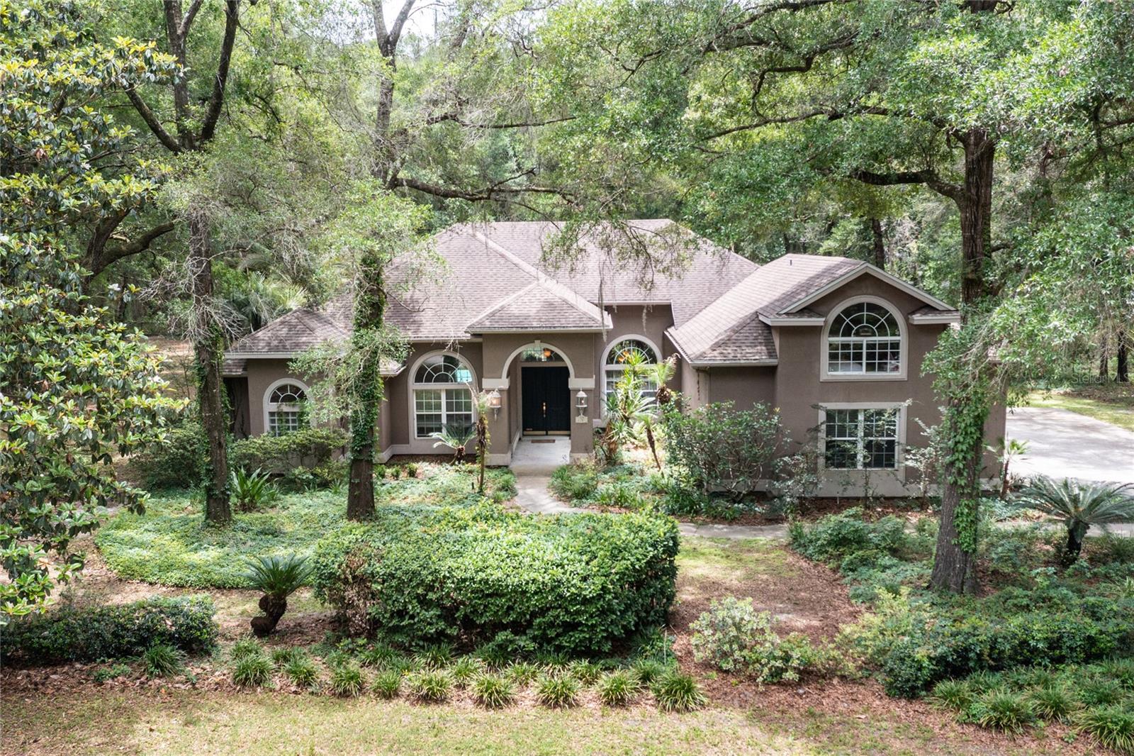 One or more photo(s) has been virtually staged. Haile Plantation Whitaker Oaks pool home! This home sits on a premium cul-de-sac, 0.83 acre lot in the idyllical Haile Plantation neighborhood of Whitaker Oaks. At 3854 square feet, the home has 5 bedrooms plus an office w/ closet ( 6th bedroom) plus 4 full baths, 3 car garage, open floorplan and 4 way split.  The Haile Village Center is just a short walk away, with local restaurants, boutiques, and a weekly farmers market, along with miles of walking trails and the fairways of Hawkstone Golf & Country Club at your doorstep. This home holds space for both connection and quiet, right where you want to be.