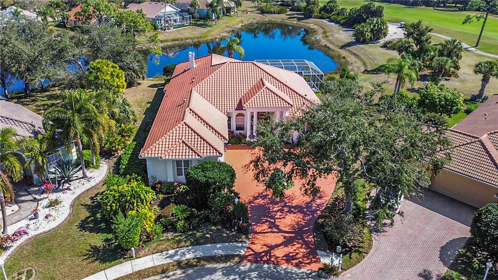 Experience refined luxury and timeless craftsmanship in this exceptional 4-Bedroom, 3 FULL BATHS & 1 HALF BATH residence with 3,203 square feet and a 3-Car Garage, ideally positioned on a PRIVATE PREMIUM lot in the prestigious Eaton Place enclave of University Park Country Club. Built by Najjar Construction, a builder known for high-quality, flawless workmanship - this elegant home blends architectural beauty with modern comfort.
Step through oversized doorways into a light-filled interior defined by 12-foot ceilings, crown molding, tray ceilings, and distinctive arched doorways with recessed wall cutouts that create architectural depth and character. Tile and wood flooring, custom built-ins, and thoughtfully selected window treatments complement the home’s refined design.  The gourmet kitchen is both beautiful and functional, featuring stone countertops, rich wood cabinetry, stainless steel appliances, a wine refrigerator, and a VIKING five-burner GAS cooktop, ideal for entertaining or everyday culinary enjoyment. Additional conveniences include CENTRAL VAC and a FOUR ZONED A/C system (2019) for optimal comfort throughout the home. Outdoor living is truly exceptional. With western front exposure, the rear of the home enjoys desirable eastern exposure, providing bright morning sun over the pool and cooler afternoons on the lanai—ideal for comfortable year-round outdoor living. The heated saltwater pool and spa overlook a serene LAKE and GOLF COURSE view, creating a breathtaking backdrop for relaxation. TWO covered lanai areas, a patio WET BAR, and an outdoor shower make the space perfect for entertaining while enjoying Florida’s beautiful climate. Hurricane shutters, impact windows near the patio wet bar, and new hurricane-rated garage doors add peace of mind. Nestled on arguably one of the most attractive lots in Eaton Place, this residence sits at the END of a QUIET CUL-DE-SAC with no through traffic, offering exceptional PRIVACY and a priceless panoramic views. Eaton Place is centrally located within University Park. Recent updates enhance the home’s value and appeal, including a newer tile ROOF (2024), new primary suite walk-in shower, freshly painted driveway (2026), new saltwater pool system and heater (2025), new refrigerator (2024), new washer and dryer (2025), and three overhead storage racks in the garage and a TANKLESS water heater. Ownership includes an automatic Resident Membership to University Park Golf & Country Club, with mandatory dues and food and beverage minimums. Golf and Racquet memberships are available. Residents enjoy 27 holes of world-class golf, tennis, pickleball, croquet, fitness and wellness facilities, and a vibrant social calendar filled with dining, holiday celebrations, and member events. Spanning 1,200 acres, the community features 20 miles of roadways and walking paths, tranquil lakes and ponds, and majestic moss-draped oaks set within lush tropical landscapes. Once you enter The Park Boulevard, you feel transported to a peaceful, park-like sanctuary. Just outside the gates, everyday convenience awaits. The home is within 15 minutes of UTC Mall, Benderson Aquatic Park and Sarasota International Airport, and within 30 minutes of downtown Sarasota and the area’s world-renowned Gulf Coast beaches, placing premier shopping, dining, arts, and waterfront recreation all within easy reach. This is a rare opportunity to own a beautifully crafted home in one of the region’s most sought-after golf communities.