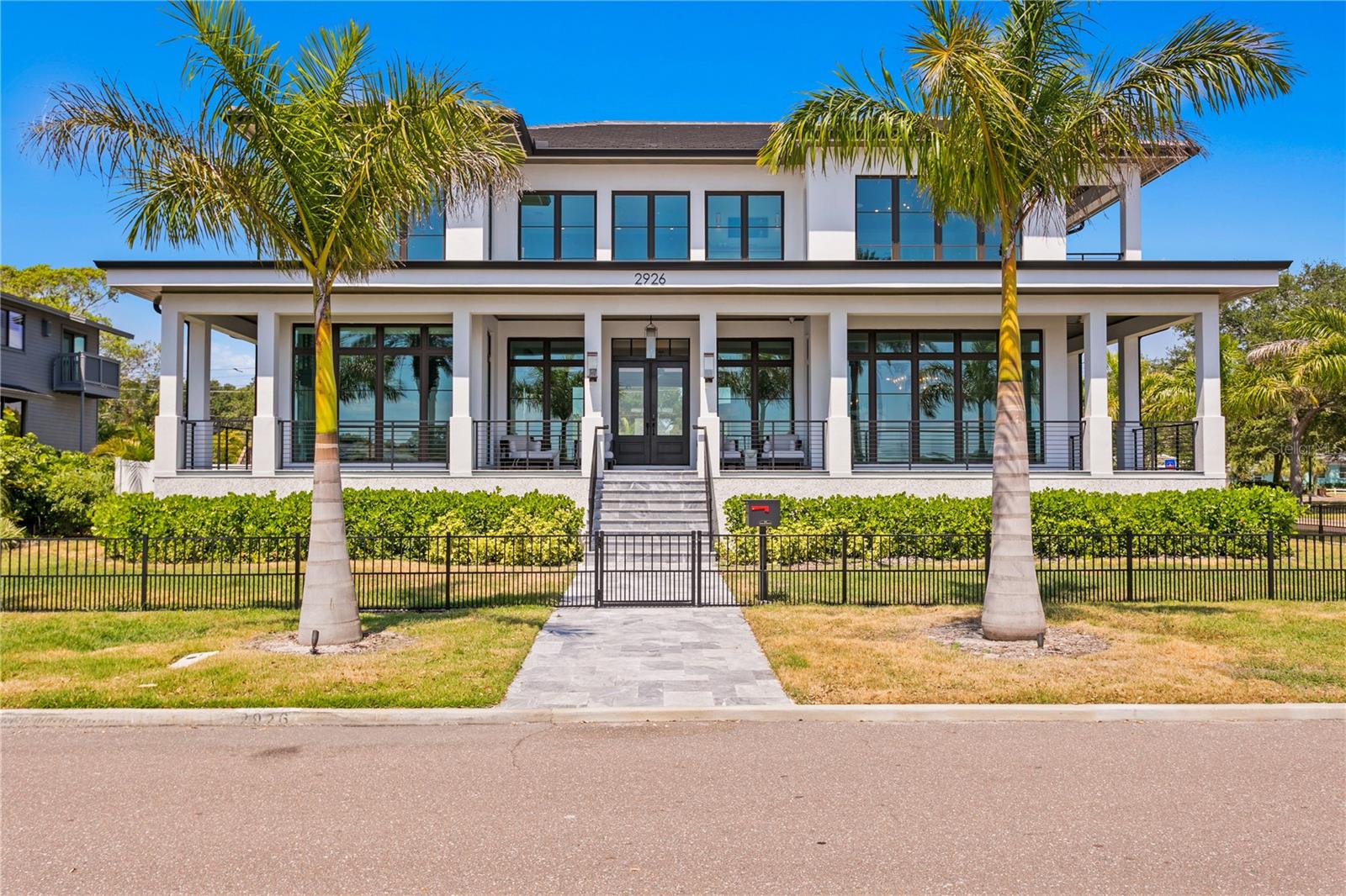Nestled along the picturesque Coffee Pot Bayou, this luxurious waterfront estate embodies refined living at every turn.

Offering 4 bedrooms, 5.5 baths spanning a spacious 5,801 sq ft of sheer indulgence, this contemporary masterpiece sets a new standard for waterfront living.

Upon arrival, guests are greeted by an expansive wrap-around porch, offering panoramic views of the tranquil bayou waters. As natural light floods the interiors through floor-to-ceiling impact-rated windows and doors, the 11’ ceilings enhance the sense of openness, creating an airy ambiance.

Designed for culinary enthusiasts, the chef's kitchen boasts top-of-the-line appliances, including a SubZero built-in refrigerator, freezer, wine chiller, a Wolf 6 burner gas range, and a Wolf built-in 30” convection oven. Taj Mahal Quartzite stone countertops and backsplash, custom cabinetry, and an expansive walk-in pantry, seamlessly blend style & functionality. For ease of cooking and entertaining this kitchen features two islands, each with stunning waterfall countertops and a large dining room off the kitchen that is surrounded by expansive windows overlooking Coffee Pot Bayou.

The grandeur continues to the living spaces, where a custom media wall crafted from marble serves as the focal point, complemented by an 85-inch framed TV, surround sound & a built-in fireplace.

The primary suite epitomizes luxury. With a private balcony overlooking the bay and park, 2 custom walk in closets, and an ensuite bath.  Features of the primary bath that make it truly one of a kind, include marble flooring, an oversized soaking tub, a spacious shower with multiple shower heads & body jets, & a wet bar with sink and beverage fridge.

The guest suites each offer unparalleled comfort and privacy, and the 4th bedroom, currently transformed into a vibrant party room, boasts a full wet bar, pool table, and custom built-in closets.

Take the convenient 3 stop elevator or one of the beautiful custom staircases to the downstairs office, which doubles as a 5th bedroom, and features a  full bathroom as well as direct access to the outdoor entertainment and pool area.

Step beyond the impeccably designed interiors into a realm of outdoor splendor. Encircled by lush landscaping and marble decking, a heated saltwater pool & spa, complete with waterfall, beckons for indulgent relaxation. Entertain in style on the lanai, furnished with a wet bar, Wolf BBQ grill, Sub Zero refrigeration, and a natural gas fireplace, all under the glow of a 75” outdoor TV accompanied by outdoor speakers.

This stunning estate also comes with your private dock that features a 13k boat lift & kayak/paddleboard drop-downs.  Here, indulge in direct access to limitless aquatic escapades or simply bask in the tranquility of the peaceful waters and playful marine life.

Meanwhile, the 2 car garage, with its oversized dimensions and 20’ ceilings, caters to the needs of automotive enthusiasts.

For the utmost convenience and security, this home is equipped with state-of-the-art technology, including a Savant Home system, Lutron automatic shades, LED mood lighting, and a comprehensive security system with exterior cameras and keypads.

With its prime waterfront location, panoramic views of Coffee Pot Bayou, perfect blend of elegance and innovation, and unparalleled attention to detail, this residence redefines luxury living offering a lifestyle of unparalleled sophistication and serenity.