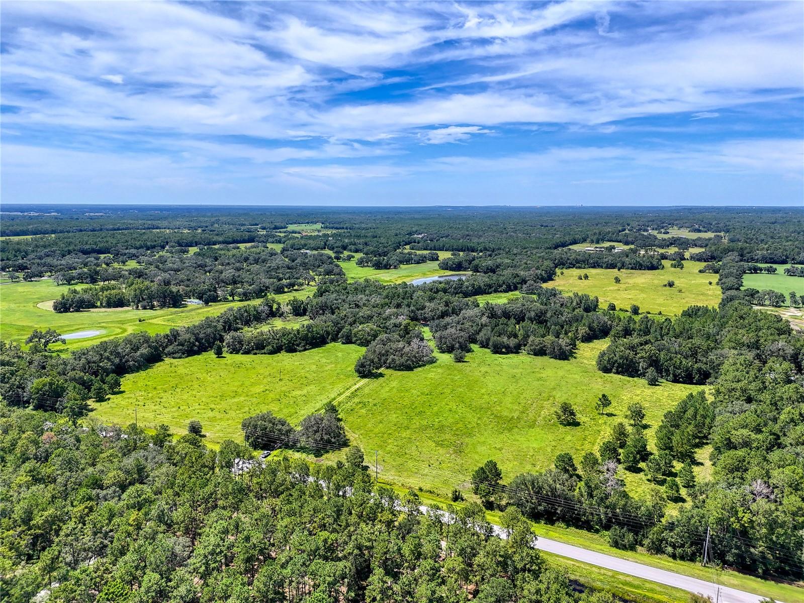 135-Acre (MOL) Estate in Central Florida – Rolling Hills, Grandfather Oaks & Boundless Potential!

Discover a rare opportunity to own 135 stunning acres in the heart of Central Florida. Nestled among gently rolling hills and framed by majestic grandfather oaks, this expansive estate borders scenic Squirrel Prairie Lake and offers the perfect balance of natural beauty, privacy, and versatile use.

Whether you're dreaming of building your forever home, developing an equestrian estate, investing in future development projects, or continuing its use as a productive working farm, this property caters to a wide range of visions.

Highlights include:

Over 100 acres of high, dry, buildable land with panoramic views and multiple homesite options.
Rolling pastures, mature oak hammocks, and serene natural water sources.
Two existing homesites, each with its own septic system, well, and electrical meter.
Established fencing and cross-fencing, ideal for livestock or equestrian use.
Zoning suitable for low-density residential or equestrian development.
Enjoy the peace and privacy of a rural setting without sacrificing convenience. The property is centrally located with quick access to major highways, making it just under an hour to Tampa and convenient to Orlando. You're also minutes from charming small towns, local markets, and recreational destinations throughout the region.

Whether you envision a private retreat beneath the oaks, a boutique residential community, or a continuation of its agricultural legacy, this 135-acre estate is a rare blank canvas ready for your unique vision.