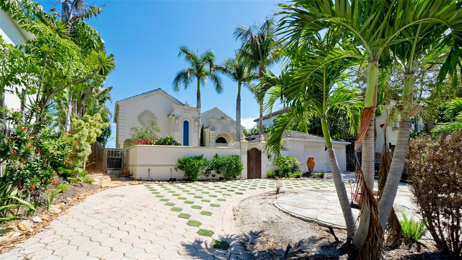 Experience the beauty of waterfront living with this exceptional home overlooking the tranquil waters of Little Sarasota Bay. This unique Siesta Key property offers 3,328 square feet of living space with three bedrooms and three-and-a-half bathrooms, combining classic coastal charm with incredible potential.

The thoughtfully designed floor plan features a spacious primary suite on the main level with a private ensuite bath, along with a second ensuite bedroom that provides comfortable accommodations for guests or family. Upstairs, the third bedroom offers added privacy and opens to a balcony where you can enjoy sweeping bay views and peaceful sunsets.

At the center of the home, a large living room with soaring ceilings creates an inviting space for gathering and entertaining. The generous layout provides a wonderful foundation for updates, allowing the next owner to customize and transform the home into their own coastal retreat.

Outside, the property truly shines. A private outdoor oasis features an inground pool and relaxing hot tub, perfect for enjoying the Florida sunshine year-round. Boating enthusiasts will appreciate the private dock with boat lift, offering direct access to Little Sarasota Bay for fishing, kayaking, paddleboarding, or sunset cruises. The home also includes a rare private sand beach area, ideal for launching a kayak or simply enjoying the waterfront setting.
The residence is accessed through a beautifully landscaped courtyard and circular driveway that adds both privacy and curb appeal.
Located in one of Siesta Key’s most desirable areas, the home is just 1 mile from Turtle Beach, 3.3 miles from Siesta Key Public Beach, and only 4.5 miles from the lively Siesta Key Village, known for its restaurants, shopping, and entertainment.

With its prime waterfront location, generous square footage, and timeless character, this property presents a rare opportunity for a new owner to make it their own and create a truly spectacular coastal home.