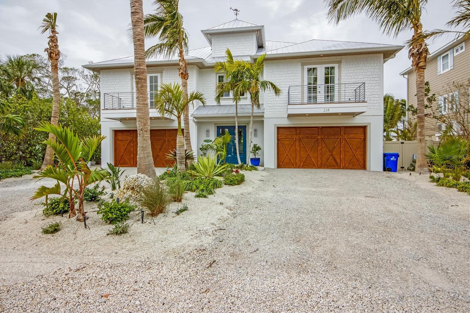 This stunning waterfront property boasts four spacious en-suite bedrooms, four and a half baths, open living area, gourmet chefs kitchen, pantry and an elevator. Large fenced in back yard, resort style pool and spa surrounded by lush landscaping. Deep sailboat water, 15,000 lb boat lift with direct access to Tampa Bay. Large, covered balcony with a wood burning fireplace. Ample storage including a 4 car garage. Located just minutes away from the beach, restaurants and shopping. This property is ideal for those seeking a vibrant and comfortable island lifestyle.