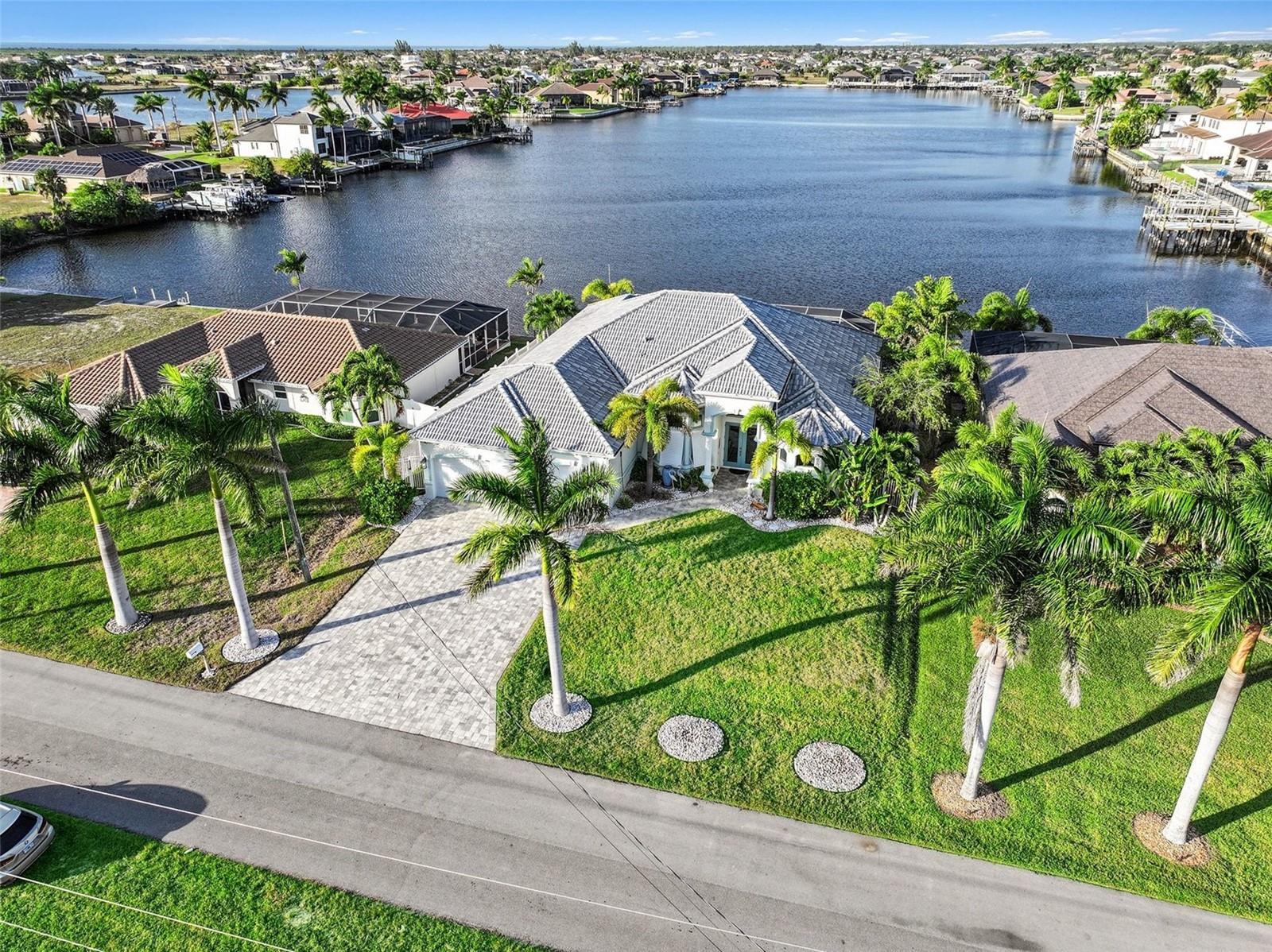 Experience premier Gulf-access living in Northwest Cape Coral, where direct boating access, wide water views, and refined design come together in a property built for both lifestyle and opportunity. With no bridges to the Gulf and a tranquil lake backdrop, this residence offers rare flexibility for investors, seasonal owners, or full-time waterfront living.

Constructed in 2018, the home features 3 bedrooms plus a den, 3 full baths, and 2,526 square feet of thoughtfully arranged living space. A split-bedroom floor plan ensures privacy for owners and guests alike, making it ideal for extended stays or rental use. Upon entering, expansive water views immediately capture attention, complemented by coffered and tray ceilings, French doors, custom cabinetry, and a soft coastal color palette that creates an atmosphere of understated elegance.

The open-concept kitchen is designed to support both entertaining and everyday living. A large center island anchors the space, while double ovens, a wine cooler, reverse osmosis system, and abundant cabinetry provide both functionality and style. The kitchen flows seamlessly into the main living and dining areas, keeping the water view as the natural focal point. A wet bar and spacious gathering areas enhance the home’s entertainment appeal.

The primary suite offers a private retreat with direct lanai access and peaceful water views. The spa-inspired bath features dual vanities, a soaking tub, and a multi-head walk-in shower. Guest bedrooms are generously sized, and the flexible den allows for use as a home office, additional sleeping space, or media room.

Outdoor living defines the experience. The expansive screened lanai creates a private resort setting complete with a heated saltwater pool and integrated spa, both enhanced by a reverse osmosis system. An outdoor kitchen, covered seating areas, and the serene lake setting provide the perfect environment for hosting or relaxing after a day on the water.

Additional highlights include impact-resistant windows and doors, concrete block construction, a tile roof, a 3-car garage, paver driveway, and strong curb appeal. With no HOA restrictions and direct access to open water, this property is positioned for continued rental success or personal enjoyment.

Conveniently located near shopping, dining, and major corridors, this home delivers boating convenience, privacy, and enduring value in one exceptional Northwest Cape Coral waterfront setting.
