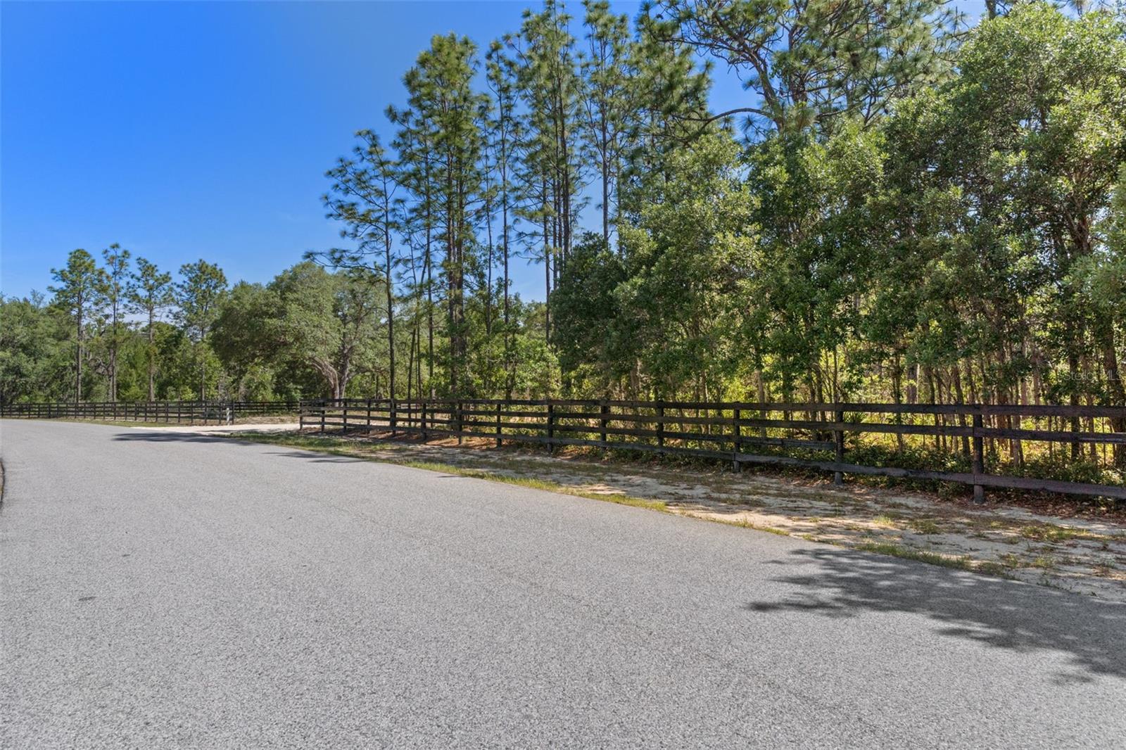 Welcome to The Preserves at Oak Hill—one of the area’s most sought-after luxury horse communities. This exceptional 5-acre parcel has already been cleared and professionally staked for construction, offering a significant head start for building your dream home. The property is fully fenced with classic black wood board fencing and is ready for immediate development.
Surrounded by stunning custom estates and luxury farms, this homesite offers both privacy and prestige. Equestrian enthusiasts will appreciate access to over 150 acres of scenic riding trails and community stalls, all within this gated community designed for horse lovers.
Enjoy a peaceful country setting while remaining conveniently located just minutes from Interstate 75, the Florida Turnpike, The Villages, shopping, hospitals, dining, and entertainment. Plus, you’re a short drive to the renowned World Equestrian Center.
With limited homesites remaining in this premier community, this is a rare opportunity to secure a prime location and move straight into the building process without the time and expense of initial land preparation.