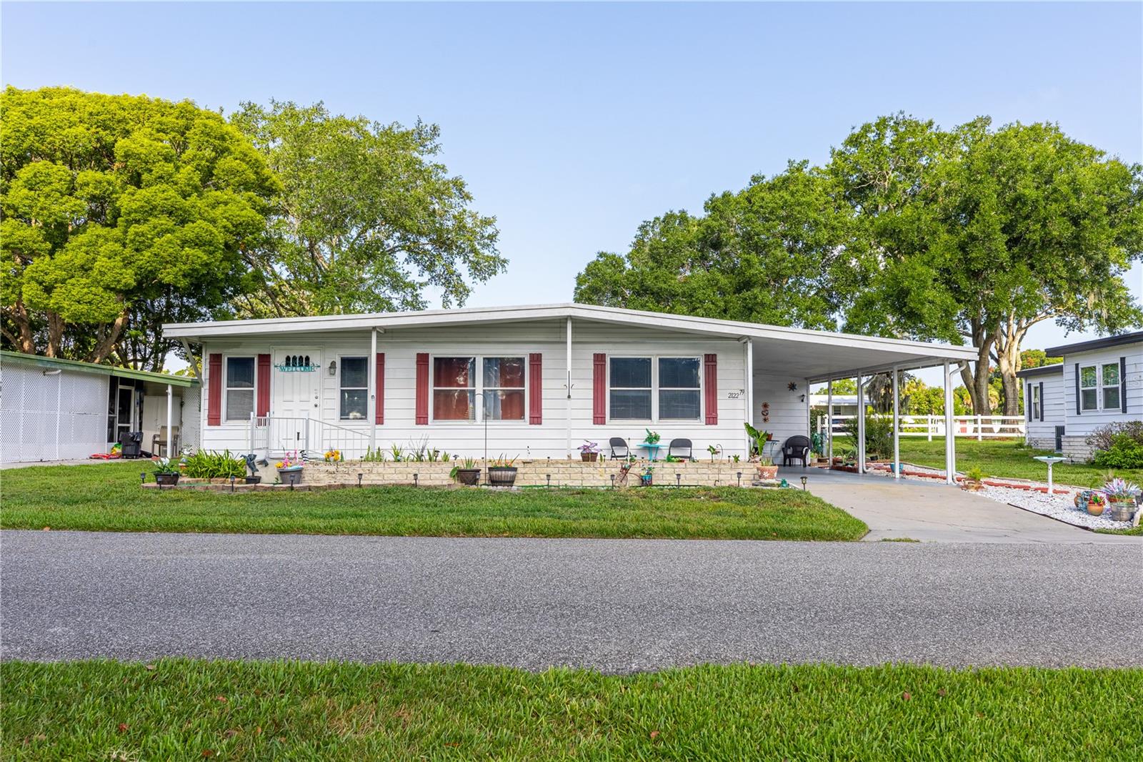 SELLER MOTIVATED in the 55+ Zellwood Station Golf and County Club Community- check out this move in ready, Furnishing are negotiable, well maintained, double wide home with $50k in upgrades, an open floor plan, new vinyl plank flooring throughout the entire house, updated walls, high ceilings (NO popcorn) with crown molding.. The primary bedroom with ensuite includes a spacious vanity with dual sinks, step in shower and walk in closet. The second bedroom also has a walk in closet and is directly across from the newly remodeled bathroom with linen closets and a step in shower. Central Florida's premier 55+ resident owned, Gated Golf Community is located in the Northwest quadrant of Orange County, just 2 miles from the 429 Expressway, which allows for easy access to the Orlando & Sanford International Airports, all the area attractions, and downtown Orlando. The home itself is a short walking distance or golf cart ride from the the Main Clubhouse. "The Depot" with resort style pool and spa, tennis courts, a greenhouse and fitness center. Enjoy the good life at Zellwood Station with it's 72 par/ 18 hole golf course,(Optional Fees and owner discounts) The Whistle Stop Restaurant & Lounge , plus banquet facilities,  pickleball & tennis courts, fishing in the two local lakes within the community, social activities and many clubs to join. A well planned, gated and active community with over 800 acres of rolling hills and tree lined streets. This home is Co-Op owned. Your low HOA includes 24 HR Maned Guard Gate, and Security, Escrow Reserves, yard and grounds maintenance, fiber optic internet services and cable. There is yard and trash pick up 3 days a week. You are located between Apopka and Mount Dora, two smaller towns with a large variety of restaurants, shopping, medical facilities and hospitals. Don't miss this hidden "gem" Call for a showing appointment today.