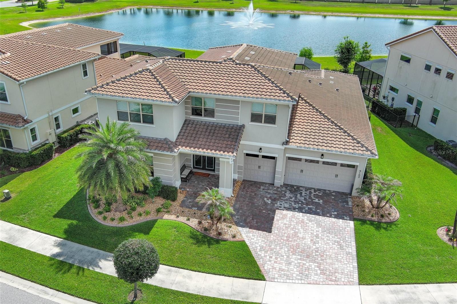 Nestled within one of Central Florida's most exclusive neighborhoods this stunning home offers the perfect blend of luxury, comfort, and effortless entertaining. Located on a quiet cul-de-sac street boasting 5 bedrooms, 4.5 baths, a large loft and open floor plan this home is designed for everyday living and seamless hosting! Step outside to your private resort style salt water pool and enjoy nightly views of the Disney fireworks lighting up the sky! The upgraded "picture frame" pool screen design offers an uninterrupted view of the serene pond and the diverse wildlife that visits it! On the main level you will find the PRIMARY SUITE COMPLETE WITH A LUXURIOUS SPA LIKE BATH AND HUGE walk-in closet, a guest bedroom with its own full bath, the glass enclosed wine room and a convenient half bath for guests.  The GOURNET KITCHEN flows to the expansive great room where 4 large sliders can open to the covered patio for the "outside inside" living!! Upstairs, in addition to the large loft are 2 bedrooms that share a full bath and another private en-suite bedroom. Recent upgrades include beams on the main level ceiling, beautiful built-in wall unit in the loft, outdoor kitchen and outdoor lighting.  Located just minutes from Walt Disney World, premier shopping, dining, and everyday conveniences, and approximately 30 minutes to Orlando International Airport, this beautiful home is perfect for that unbeatable central Florida lifestyle!
