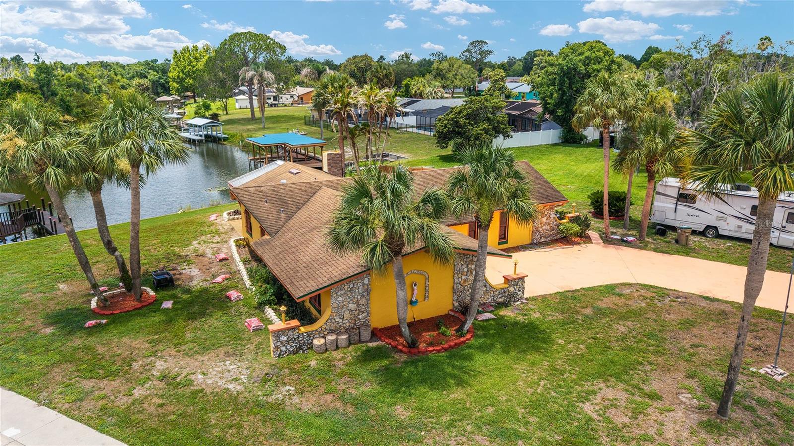 Paradise awaits in this spectacular waterfront pool home, a true nature lover's dream, offering an impressive 140 feet of prime canal frontage with direct access to Lake Griffin and the renowned Harris Chain of Lakes. Inside, you'll find a beautifully remodeled home featuring gorgeous flooring throughout with no carpet, fresh interior paint, a gourmet chef's kitchen, and stunning, one-of-a-kind designer bathrooms. The spacious Florida room is the perfect place to unwind while enjoying breathtaking views of the tranquil waterway and surrounding bird sanctuary—all from the comfort of air-conditioned living. The oversized primary suite offers a peaceful retreat and includes an exceptionally large walk-in closet. Step outside to your own private resort-style oasis. The thoughtfully redesigned pool area features a newly fenced perimeter, an elegant tiled sun deck with a dedicated walkway to the deep end, and an integrated gazebo perfect for relaxing or entertaining. Eight mature palm trees surround a massive designer planter, creating a lush tropical setting. Water enthusiasts will love the brand-new dock and the additional waterfront gazebo, providing the ideal spot for morning coffee, evening sunsets, fishing, or launching your boat for endless adventures on the Harris Chain of Lakes. This exceptional property seamlessly blends luxury, privacy, and the ultimate Florida waterfront lifestyle.  The monthly Rental amount is $3,350 but it also covers the following:  water, pool maintenance, ADT security, and lawn mowing.