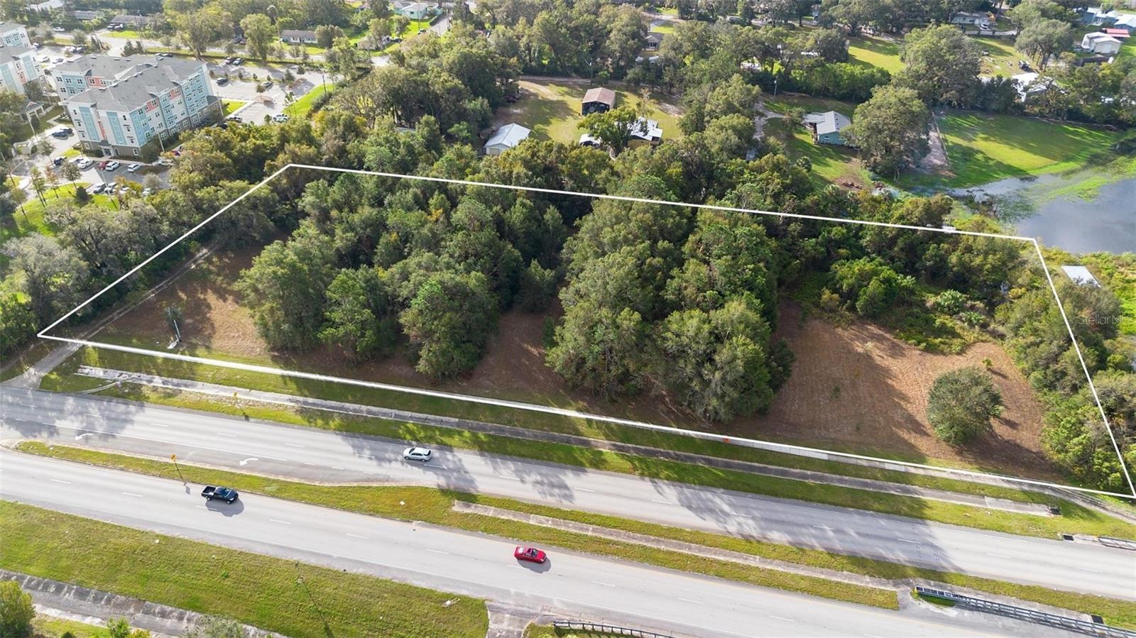 •Located on the high-traffic International Speedway Blvd (ISB/US-92) corridor in DeLand, this 4.12-acre parcel offers a unique investment or development opportunity driven by its versatile A-3C zoning. The "C" designation indicates a Thoroughfare Overlay Zone, a critical factor that signals the property's potential for future commercial transition or high-visibility professional use. With average daily traffic counts ranging between 25,000 and 32,000 vehicles, the site provides exceptional exposure for businesses looking to capture the steady flow of commuters and travelers moving between the historic DeLand district and the coastal hubs of Daytona Beach. 
•The property is ideally suited for a variety of high-interest groups. Commercial developers and land-bank investors are likely to see the 4.12 acres as a prime candidate for a future "path of growth" project, such as a retail strip, professional office complex, or equipment rental center. Alternatively, the A-3 classification allows for a minimum one-acre lot size, making the land attractive to small-scale residential builders or "mini-farm" enthusiasts who wish to create a private three-to-four-lot estate enclave without the restrictions of a traditional HOA. This size also perfectly accommodates specialized agricultural entrepreneurs, such as those looking to establish a retail nursery, garden center, or agritourism venture that can capitalize on the direct road frontage.
•Current market trends in the DeLand area further enhance the property's value, particularly with the nearby expansion of major industrial and mixed-use projects like the DeLand Tech Park. While the Thoroughfare Overlay requires adherence to specific setbacks and landscape buffers to maintain the corridor's aesthetic, these regulations ensure a professional environment for long-term appreciation. Whether utilized for a custom residential estate with ample room for workshops and recreational equipment or pivoted toward a General Commercial (B-4) use, this acreage stands as a strategic asset in one of Volusia County’s most active development zones.