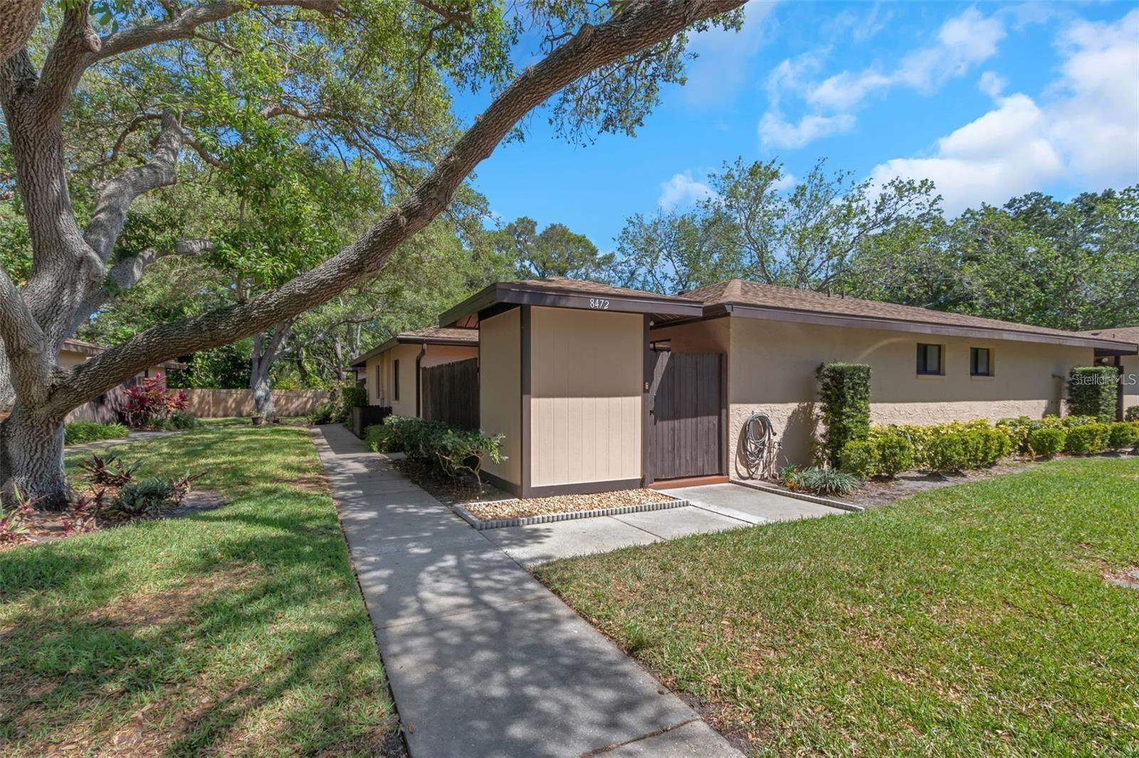 Charming 2-Bed, 2-Bath Villa – A Private Retreat, Open to All Ages!

Tucked away in a cozy little building with just 40 villas total, this home already feels special the moment you arrive. And that feeling only grows once you step inside.

The split floor plan gives everyone their own space, while the fenced-in private garden/patio invites you to sip your morning coffee outdoors—just you, the flowers, and maybe a happy pup by your side (yes, it’s pet friendly!).

Inside, the modern kitchen is a pleasant surprise: loads of cabinets and a walk-in pantry mean you’ll never wonder where to put the groceries. There’s also a breakfast bar and a cozy spot for a small kitchen table—perfect for quick meals or a quiet cup of tea.

No need to haul laundry anywhere—the full-size washer and dryer are included and neatly tucked into their own closet.

The primary bedroom is a true escape—large, with a walk-in closet, an updated en suite bath, and a nice walk-in shower. And there’s even another walk-in closet off the living room. Yes, you read that right. Storage lovers, rejoice!

The second bathroom has a tub with a shower—great for guests or relaxing soaks.
And outside? You’ve got an extra storage unit for beach gear, tools, or seasonal decorations.

Recent updates include fresh exterior paint and a newer roof, so you can move in with peace of mind. Plus, hurricane shutters add security and comfort during storm season.

Low maintenance fees keep this home affordable, and you’ll appreciate two assigned parking spaces just for you.

And the location? Oh, it’s good. Just minutes from a recreation center, pool, and park. Easy access to shopping and restaurants. And only about:

15 minutes to the beautiful Gulf beaches

15 minutes to Tampa Airport

30 minutes to downtown St. Petersburg

This isn’t just a villa—it’s an easy, carefree Florida lifestyle. All ages welcome. Come see it for yourself.