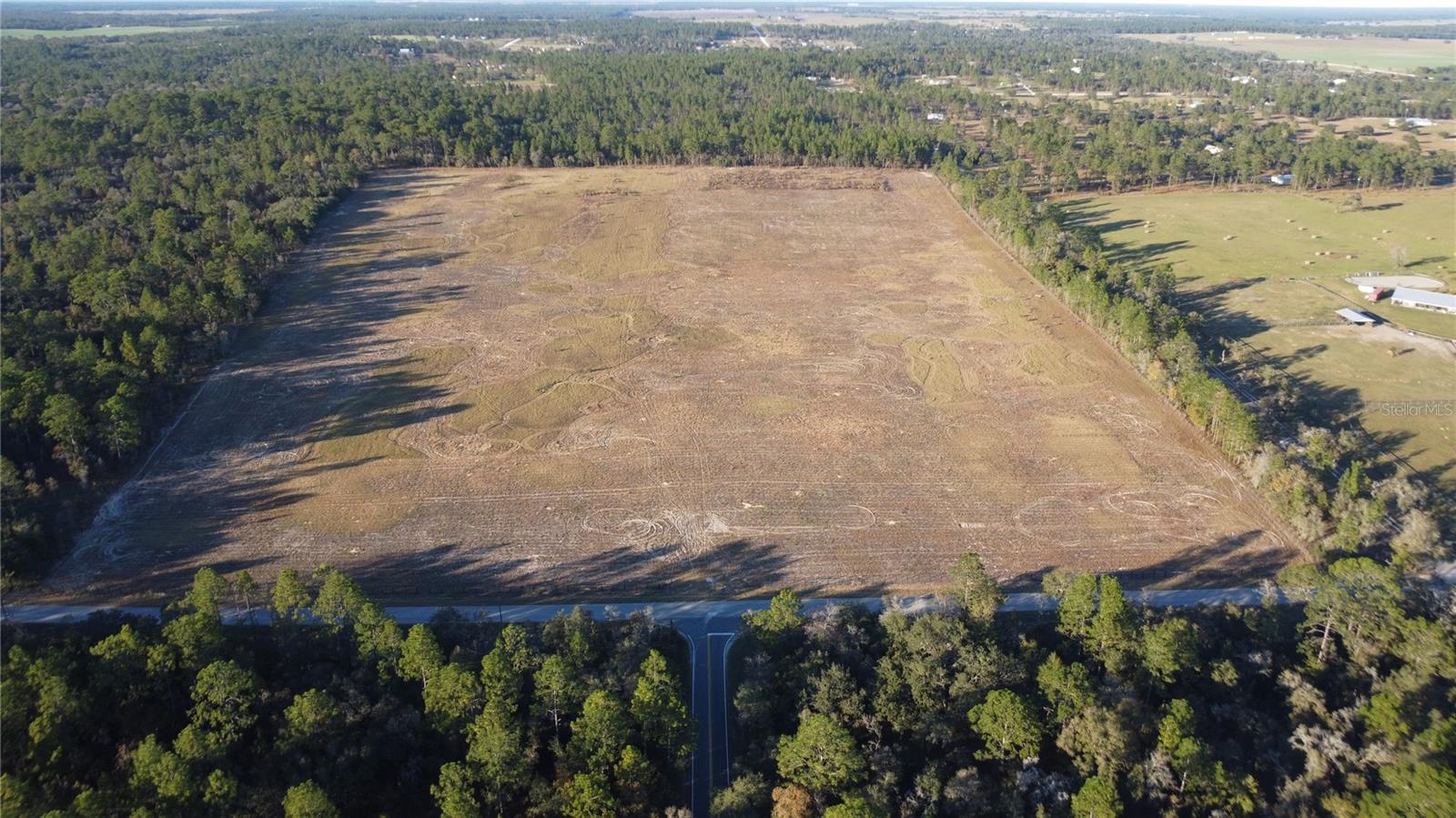 40 ACRES OF WIDE-OPEN FLORIDA LAND — BUILD YOUR DREAM FARM OR COUNTRY ESTATE! If you’ve been searching for space, freedom, and beautiful Florida countryside, this 40-acre cleared property offers the perfect canvas. With paved road frontage and wide-open pastures, the land is ideal for a private estate, horse property, mini-farm, or weekend retreat. Toward the back of the property, a natural hill creates a stunning homesite location, perfectly positioned to capture cool breezes and peaceful views across your own acreage. Imagine watching the sunrise from your porch, riding horses across your land, or creating the farm or homestead you've always dreamed about. With no HOA and no deed restrictions, you have the flexibility to build the lifestyle you want. Site-built homes or manufactured homes are both welcome, giving you the freedom to design the property to fit your plans. Located in the heart of North Central Florida’s horse country, you’ll enjoy convenient access to World Equestrian Center (WEC), HITS Ocala, Goethe State Forest riding trails, and the charming towns of Williston, Dunnellon, and Ocala. Large acreage like this — cleared, usable, and priced to sell — is becoming harder to find. Come walk the property and start imagining the possibilities.