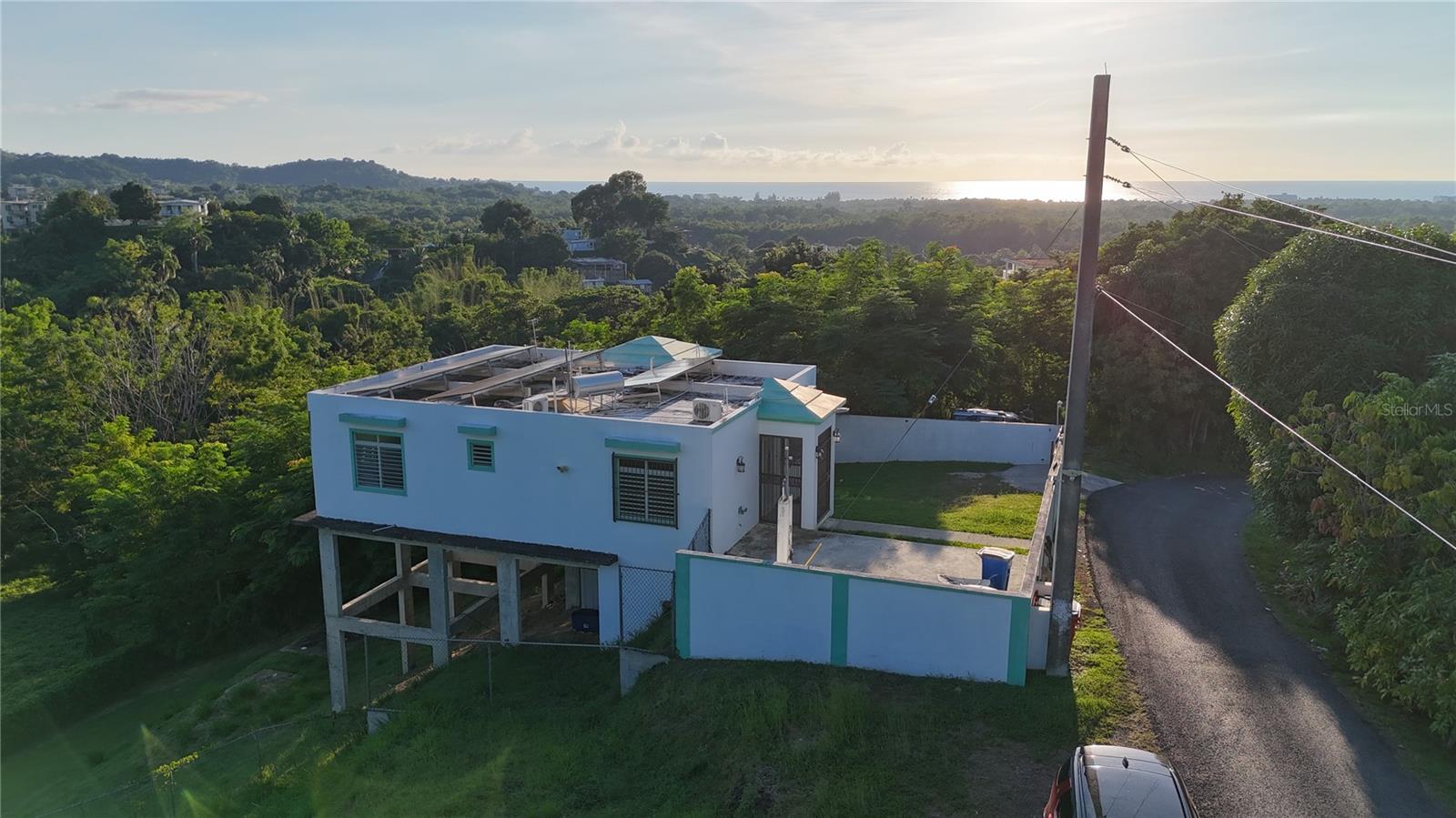 Mountain Privacy with Ocean Views – A Rincón Rare Find
Tucked away in the mountains yet minutes from the surf, this 3-bedroom, 1-bath home offers the privacy of a remote retreat with the convenience of downtown Rincón just down the road. Sitting on a 972.66 sqm lot.
The property captures constant hillside breezes and a clear ocean view. With solar panels already installed (batteries need repair/replacement), the foundation for energy efficiency in place.
This is a true blank canvas. Whether your vision is to renovate the existing structure, build upward to maximize the vista, or expand across the generous lot footprint, the potential here is unmatched.