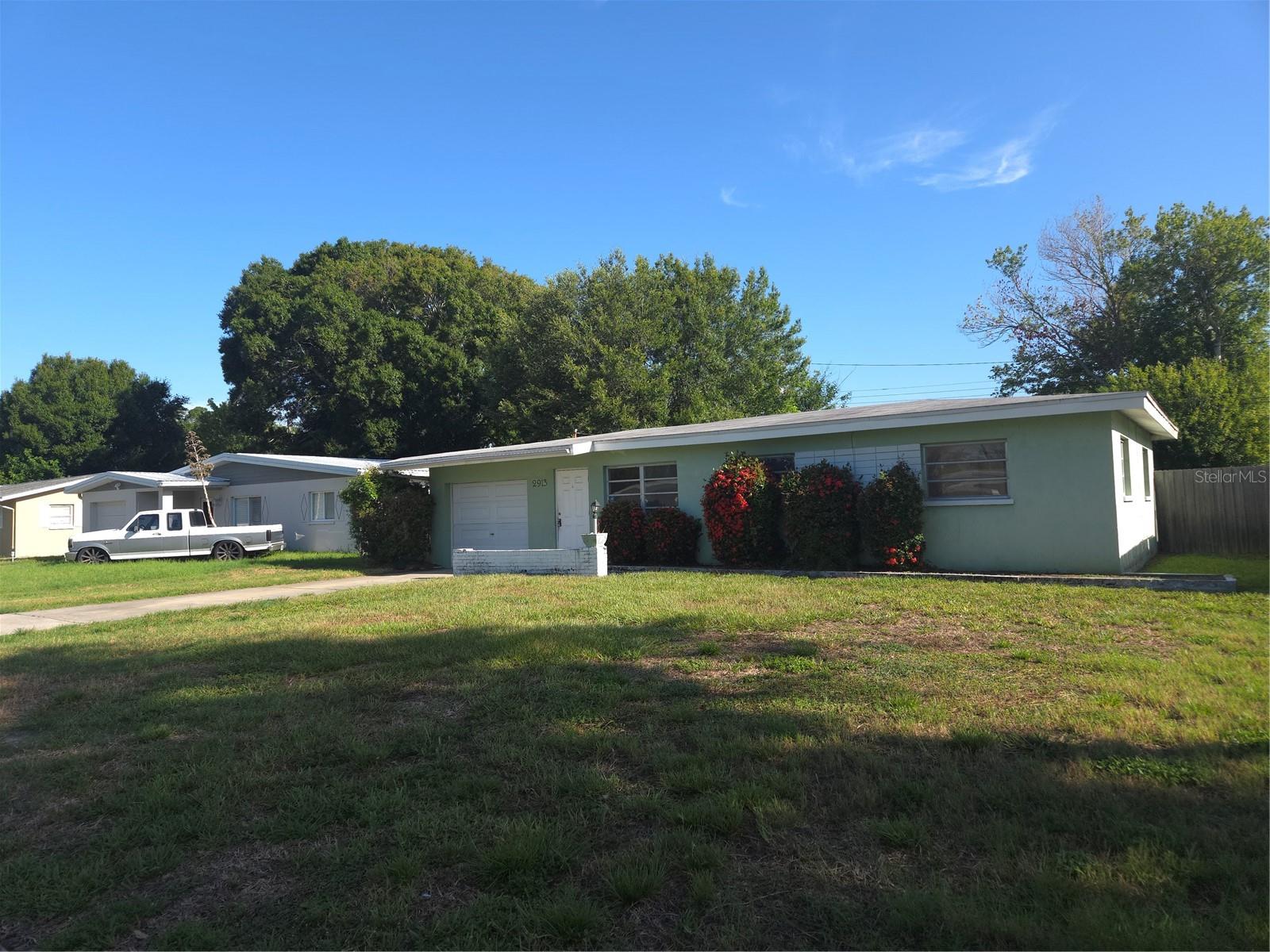 Perfect home for investors! This is a 3-bedroom 2 bath home with a 1 car garage. It needs TLC but will be a great starter home, flip or rental.
Walk into a living dining combo with a slider to a screened in patio off the dining/kitchen area.  Bedrooms are down the hallway near the bathroom. A pedestrian door from the dining/kitchen area will lead you to the one car garage, washer/dryer hookups and 2nd bathroom.