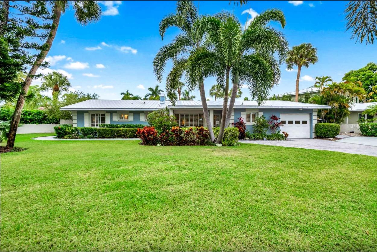 Welcome to your private coastal sanctuary just moments from the powder-soft sands of Lido Beach and a short stroll to iconic St. Armands Circle. Perfectly positioned in one of Sarasota’s most coveted locations, this stunning residence captures everything buyers dream about when they imagine luxury living by the gulf. From the moment you arrive, lush tropical landscaping and swaying palms frame a beautifully maintained property that feels both secluded and inviting. The expansive paver drive and manicured lawn create a grand first impression, while mature greenery provides privacy rarely found this close to the beach. Inside, the home blends refined elegance with relaxed island charm. Sunlight pours through plantation-shuttered windows, illuminating spacious bedrooms designed for comfort and style. The primary suite is a tranquil retreat with soft coastal tones and garden views, while the guest rooms are thoughtfully appointed to accommodate family and visitors with ease. Every space feels bright, airy, and curated for effortless living. The bathrooms are nothing short of spa-worthy. Floor-to-ceiling tile, frameless glass showers, custom vanities with stone countertops, dual sinks, and elegant fixtures create a luxurious experience that rivals high-end resorts. Thoughtful details like recessed niches, designer mirrors, and soft lighting elevate each space. Step outside and the property truly comes to life. The private backyard oasis is designed for unforgettable gatherings and serene relaxation alike. A sparkling pool is surrounded by expansive decking, lounge seating, and tropical landscaping that transforms the space into your own secluded resort. String lights overhead add ambiance for evening swims, while shaded seating areas invite long afternoons under the palms. The fenced yard enhances privacy, creating a rare sense of retreat just minutes from everything. And the location — simply exceptional. Imagine morning walks to Lido Beach, sunset cocktails at St. Armands Circle, boutique shopping, award-winning dining, boating, and downtown Sarasota’s vibrant arts scene all just moments from your front door. Homes in this location with this level of finish and established rental success are incredibly rare. Whether you are searching for a luxury island residence, a sophisticated vacation retreat, or a high-performing investment property with proven appeal, this home delivers on every level. Offered in pristine condition and designed for both comfort and entertaining, it embodies the very best of coastal Florida living. This is more than a home. It is the St. Armands lifestyle — elevated, private, and unforgettable.
