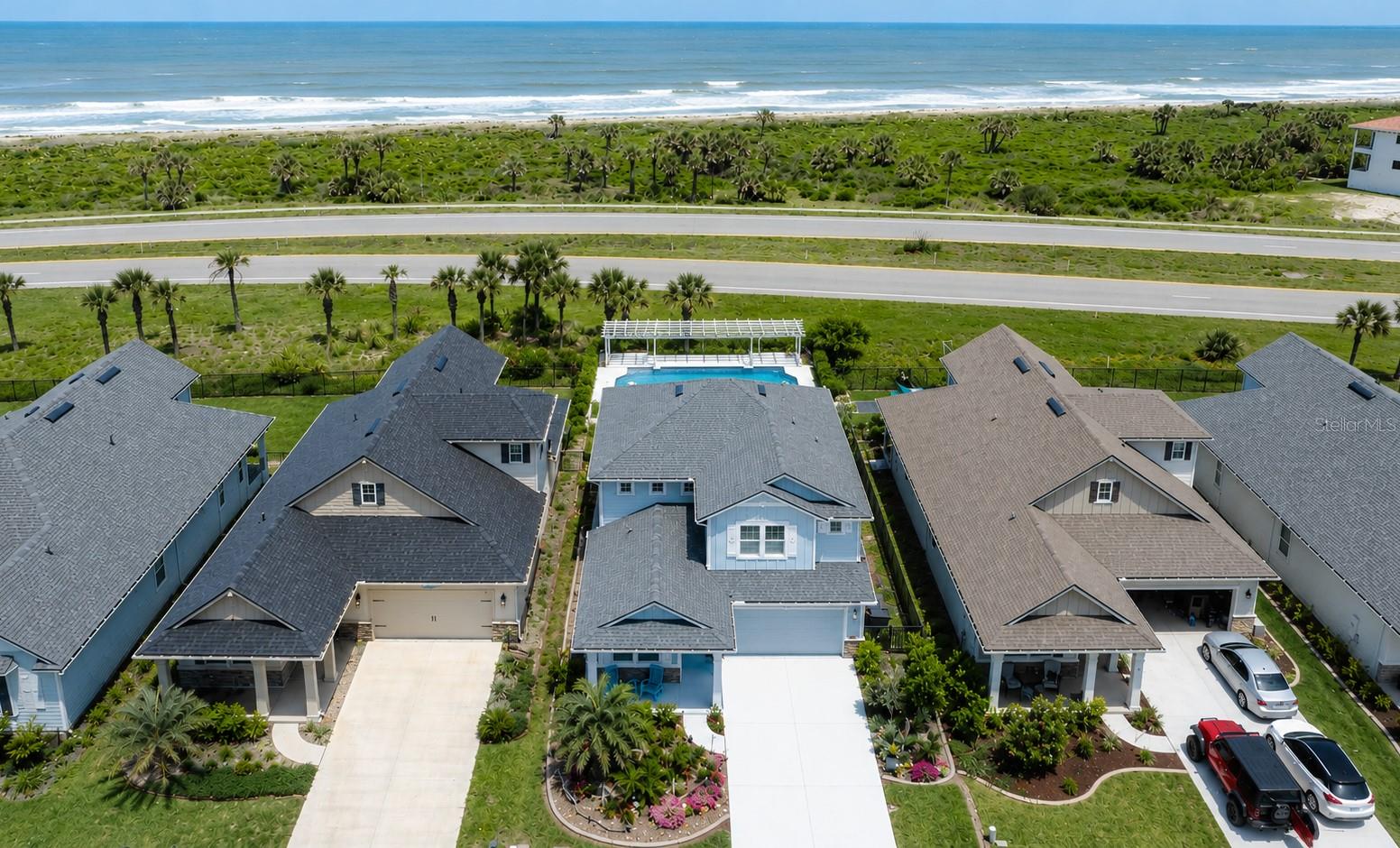 One or more photo(s) has been virtually staged. Welcome to 20 Los Lagos Boulevard, an exceptional coastal residence in the gated community of Matanzas Shores, where luxury living meets the ultimate Florida beach lifestyle. Built in 2022 and loaded with upgrades, this 4-bedroom, 3.5-bath property offers 2,665 square feet of thoughtfully designed living space, including the highly sought-after feature of two primary suites—one on each level—providing ideal flexibility for guests, multigenerational living, or a private owner's retreat. Situated just a short walk from the beach, the home enjoys ocean views from the second floor and is positioned across from HOA-owned preserve land, creating a beautiful natural buffer leading toward the coastline and enhancing the private coastal setting. A rare advantage for beachside living, this property is not located in a flood zone while still offering incredible proximity to the Atlantic Ocean.

The backyard is truly the showpiece of this property, featuring a custom-built saltwater pool and spa with water features, electric heat, expansive outdoor entertaining areas, pergola privacy fencing, and low-maintenance artificial turf. Whether hosting family and friends or enjoying a quiet evening under the stars, this outdoor oasis delivers the resort-style experience buyers dream about when moving to Florida. Inside, the open-concept design is enhanced by luxury vinyl plank flooring, upgraded stair railings and hardwood stairs, plantation shutters, abundant natural light from additional builder-upgraded windows, and a spacious great room that seamlessly connects to the outdoor living areas.

The gourmet kitchen showcases quartz countertops, custom backsplash, upgraded cabinetry with accent lighting, pull-out storage, drawer upgrades, Lazy Susan cabinetry, exhaust fan, and an oversized island designed for both entertaining and everyday living. Additional upgrades include raised-height primary bath cabinetry, upgraded bathroom finishes, video-monitored security system, water softener system, hurricane shutters, extra hurricane bracing, upgraded insulation, and prewiring already completed for a whole-house generator—an invaluable feature for coastal living. The garage is equally impressive with epoxy flooring, ceiling-mounted storage racks, and a utility sink offering both hot and cold water. The hot water heater also includes a recirculation pump designed to improve hot water delivery throughout the entire home.

Beyond the property itself, Matanzas Shores offers one of the most impressive amenity packages on Florida's east coast. Residents enjoy private deeded beach access, an oceanfront community pool, tennis and pickleball courts, volleyball court, clubhouse, Intracoastal day dock, kayak storage, and additional community gathering spaces—all within a beautifully maintained gated setting.

Ideally located along the scenic A1A corridor, the community is just minutes from Matanzas Inlet, the pristine beaches of the Matanzas Shores coastline, and the natural beauty of Washington Oaks Gardens State Park. Historic downtown St. Augustine, world-class dining, shopping, boating, fishing, and miles of unspoiled beaches are all within easy reach, offering a lifestyle that perfectly blends luxury, recreation, and coastal living. This move-in-ready retreat delivers the perfect combination of location, lifestyle, and modern Florida luxury.