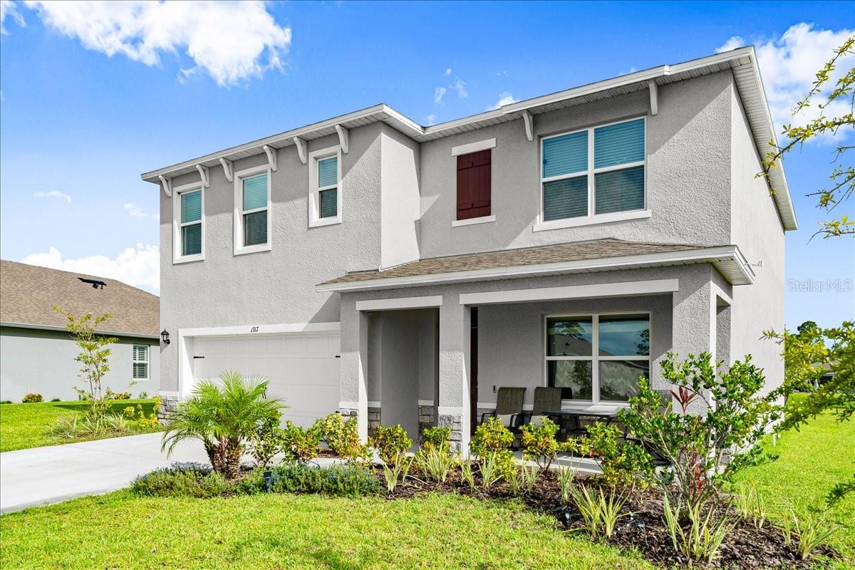 This 5-bedroom, 3-bath home sits on a spacious lakefront lot in Halifax Plantation, one of Ormond Beach's most established communities -- and at just over 2,600 sq. ft., it's built for a family that needs room to spread out without feeling like they're rattling around in wasted space. The layout is practical. A first-floor bedroom works as a guest room, nursery, or home office depending on where life takes you. Upstairs, four bedrooms share a lounge area that naturally becomes the hangout spot, a homework zone, or a second living room -- the kind of flexible space growing families actually use. The kitchen is set up for real daily life: granite countertops, a full pantry, and an open layout that keeps you connected to the main living areas whether you're making lunches or hosting dinner parties. The primary suite is on the larger side at 20'x13', with a walk-in closet and a step-in shower -- a quiet space to close the door at the end of a long day. Outside, the lakefront lot offers the kind of backyard that earns its keep: room for the young ones to play, mature landscaping already in place, and an irrigation system so you're not spending weekends dragging hoses. Square footage received from tax rolls. All information recorded in the MLS intended to be accurate but cannot be guaranteed.