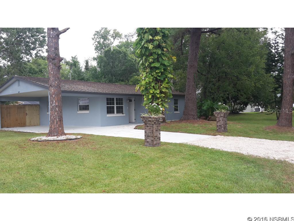 This is a gem!!!!!Completely remodeled from the studs in. Cement block/stucco. New kitchen with granite counters. All new windows. Laundry room with washer and dryer. Entire new AC system. Corner lot with house facing onto unopened street. Curb appeal is great with flower boxes atop brick pillars accented by tall mature trees. Bathrooms have been completely remodeled. All floors are high end laminate. Tankless water heater. Back yard is completely fenced with stockade fencing. This home is truly a gem ;Water: City