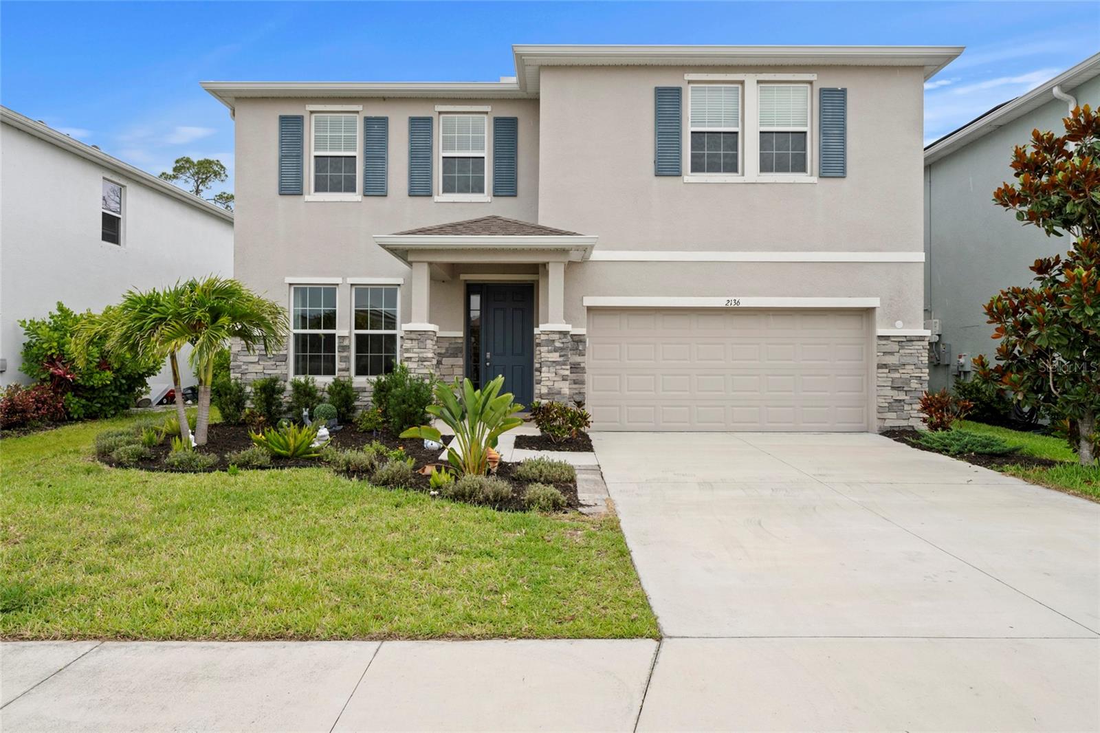 Welcome to this impressive two-story residence nestled within the highly sought-after Bay Landing community in Sarasota. From the moment you arrive, stacked stone accent columns, lush landscaping, and a striking slate-blue front door create exceptional curb appeal and a memorable first impression. Step inside to a bright and welcoming foyer, where decorative tile flooring and an elegant entryway set the tone for the thoughtfully designed interior. The expansive open-concept floor plan seamlessly connects the kitchen, dining area, and great room, creating an ideal setting for both everyday living and entertaining. At the heart of the home, the chef-inspired kitchen showcases rich dark cabinetry, gleaming granite countertops, a subway tile backsplash, stainless steel appliances, and a large center island with breakfast bar seating. Overlooking the spacious great room, a tray ceiling adds architectural character and enhances the home's inviting atmosphere. A versatile flex room on the main level offers endless possibilities and can easily function as a home office, formal sitting room, or hobby space, and additonal mudroom. Upstairs, a spacious bonus living area provides the perfect retreat for relaxation, recreation, or family gatherings. The private primary suite serves as a true sanctuary, featuring a tray ceiling, generous walk-in closet, and a spa-inspired ensuite bath complete with dual vanities, a soaking tub, and an oversized walk-in glass shower. Additional bedrooms are generously sized and offer ample closet space, ceiling fans, and access to a well-appointed full bathroom. A conveniently located upstairs laundry room adds everyday convenience. Step outside to the screened lanai, where paver flooring, a ceiling fan, and a lush natural backdrop create a peaceful setting for morning coffee or evening relaxation. Residents of Bay Landing enjoy low HOA fees, no CDD fees, and access to an outstanding collection of resort-style amenities, including a clubhouse, sparkling community pool, fitness center, dog park, playground, and beautifully maintained parks and sidewalks throughout the neighborhood. Surrounded by majestic canopied oak trees, Bay Landing offers a tranquil, nature-inspired setting with a welcoming community atmosphere. Ideally located just east of I-75, this home places you minutes from the premier shopping, dining, and entertainment destinations of University Town Center (UTC), Waterside Place at Lakewood Ranch, Lakewood Ranch Main Street, and vibrant Downtown Sarasota. Enjoy easy access to renowned Gulf Coast beaches, including Siesta Key and Lido Key, while Sarasota-Bradenton International Airport is conveniently located just eight miles away. Top-rated schools further enhance the appeal of this exceptional location. Offering an exceptional combination of space, style, modern updates, and an unbeatable location, this Bay Landing residence presents an outstanding opportunity to enjoy the very best of the Sarasota lifestyle. Is this home your perfect match?!