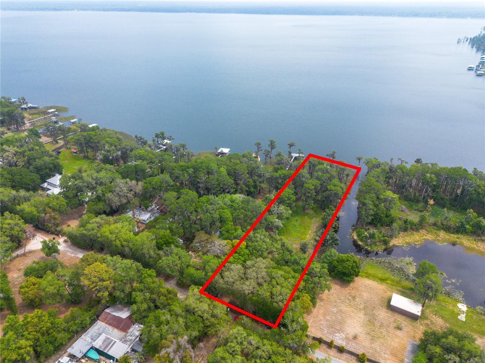 Professional pictures coming very soon!  

Amazing 103 feet of Lake Santa Fe frontage and a 1100 SF cottage with durable and timeless pecky cypress siding.  3 bedrooms and 1 full bathroom and a good sized kitchen with a 10 year old metal roof.  For some amazing views, use the stairs on the back of the house to step up to the rooftop and hang out.  Walk out your back door to Lake Santa Fe or drop your kayak into the canal - both are easily accessible from your property.  The property is literally 20 minutes to the Gainesville Airport and about the same to NW Gainesville.  

This is Finally your chance to own on Lake Santa Fe without spending a million dollars!