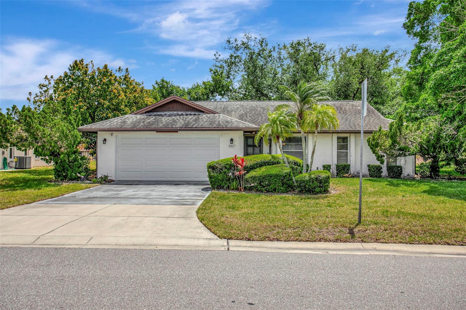 This charming 2-bedroom, 2-bathroom home with a large 2-car garage offers comfortable Florida living on a spacious corner lot with mature landscaping and a park-like view. The combined living and dining area features vaulted/cathedral ceilings, creating an open and airy feel throughout. A large enclosed Florida room provides the perfect space to relax and take in the scenic surroundings. The kitchen is equipped with updated stainless steel appliances and bar seating. New home generator included! The primary suite includes dual sinks, a large walk-in closet, and direct access to the Florida room. HOA amenities include a large swimming pool, a gazebo with lake views, tennis courts, and more. Conveniently located near shopping, dining, beaches, and everyday amenities, this home is ideal whether you're looking for a primary residence or an investment opportunity. The city of Bradenton is potentially paying close to six figures in the coming years for a portion of the owned land! The option to purchase furnished is available. Schedule your showing before it’s gone!