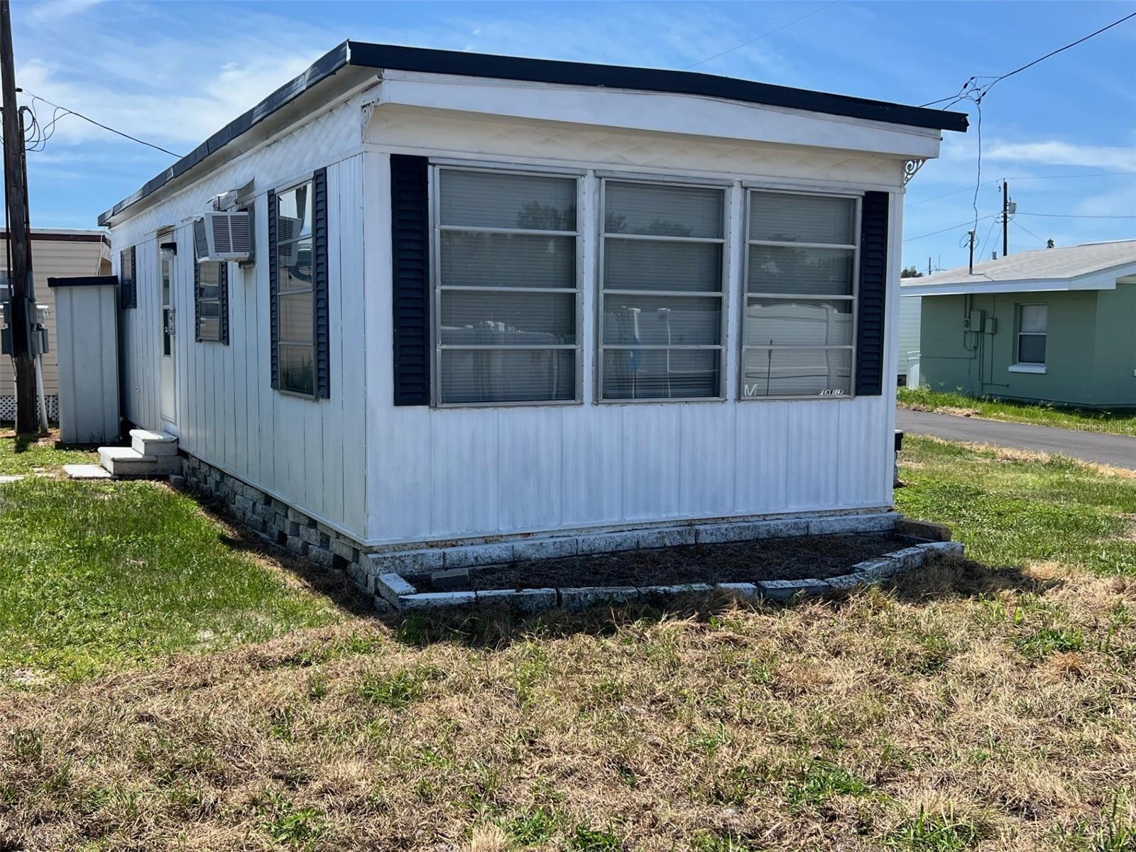 If you’re seeking an inviting 55-plus community, this new listing of a one-bedroom, one-bath home in Midway AM/CAN might be perfect for you! Located in a friendly neighborhood with amenities to enhance your lifestyle, it features a community clubhouse just steps away, where residents meet for social events, activities, and to enjoy the well-kept shuffleboard courts. Additionally, the community provides a pay-by-use laundry facility equipped with washers and dryers, complemented by an outdoor drying yard.  The home sits on a corner lot surrounded by open space, giving it a bright, airy feel—ideal as a winter getaway! The low maintenance fee of $192.00 per month covers water, sewer, trash, and lawn care. You’ll be close to Tampa Bay, Gulf beaches, restaurants, and shopping, and the park allows up to two cats. This home combines contentment and community in one attractive package!  INTERIOR:  Full of promise, this home presents a kitchen outfitted with all essential appliances, a petite eating area, and impressive storage options—including two built-in cupboards with glass doors that are perfect for displaying cherished items. The inviting living space is ideal for movie nights or entertaining guests, while a heating and air conditioning unit keeps things cozy. There's also a practical sleeper sofa in the living room-perfect for hosting last-minute guests. The bathroom includes a practical tub-and-shower combo. In the bright, airy bedroom, a mini-split system ensures year-round solace, and abundant storage is provided by two closets and built-in drawers. Featuring laminate floors throughout, attractive wall panels, and a ceiling fan, this home offers a great foundation with plenty of potential for upgrades and personal touches!  EXTERIOR:  This home features durable aluminum siding paired with a metal roof which has recently been sealed for added protection and longevity. An outdoor shed provides the perfect solution for extra storage, while ample space allows room for two vehicles to park with ease. Priced at a tremendous $29,500, with a share included, this property is enjoyable as is, with the freedom to make it uniquely yours. Call to schedule your private showing!