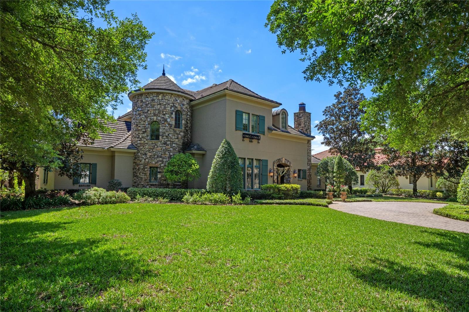 The “Monet” is a masterpiece of exquisite details, elegant finishes and architectural elements. Built by Master Custom Builder Castleworks, this French Country home is in the exclusive guard gated Reserve at Lake Butler Sound. 

Situated on a corner lot, the fresh landscape and exterior lighting highlight the beauty of the stone turret, chimney, arched entry and circular front drive. From the welcoming entry loggia and reception foyer, to the arched gallery, grand salon with stone fireplace and views to the covered terrace beyond, exquisite details surround you. Throughout the home’s interior, you’ll find intricately detailed crown molding, coffering, large beams accenting the ceilings, gracefully arched doorways, polished stone floors and stunning millwork that set a warm and inviting tone. 

Epicurean delights flourish in the gourmet chef’s kitchen with custom wood cabinetry and pantries. Cook with Wolf and Sub Zero appliances, including a six burner gas range, freshly polished center island with prep sink, and Fisher Paykel double drawer dishwasher. The granite-top breakfast bar and dining area with balcony overlooks the spacious family room, featuring French doors and panoramic views of the beautiful resort-style pool. The backyard features include a large screened lanai, outdoor living room with fireplace and well-appointed summer kitchen. The magnificent resort-style pool with spa is surrounded by lushly landscaped grounds.

From the owner's retreat vestibule enter the intimate master suite with double French doors to the covered terrace. The opulent master bath features a floating whirlpool bath with beautiful fixtures, barrel-beamed ceiling, walk-through shower and a spacious wardrobe room with dressing area. 

Tucked under the circular stairs is a stone wine cellar. Completing the first floor tour, the fifth bedroom or library suite includes a full bath and walk-in closet.

Ascend the dramatic stairway to the second floor spacious game loft with custom built-in cabinetry and three additional bedroom suites — each with private bath and walk-in closet. Perfecting this residence are separate two-car and one-car garages framed by a private brick paver motor courtyard, a magnificent resort pool with heated spa, & lushly landscaped grounds.

This exquisite property is situated near Lake Butler, widely regarded as the most sought after lake in the Windermere chain. With almost 6,000 square feet of true luxury, this beautiful estate offers complete privacy in this coveted neighborhood.