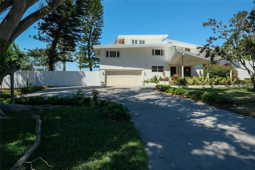 Sarasota School Of Architecture.  This 6 bedroom, 3 bath home sits directly on the Sarasota Bay, and Intracoastal Waterway offering crystal clear views to the world-famous Ca d’Zan. This multi-level home sits on a huge double lot allowing for development opportunities. Meticulous landscape surrounds the property setting the tone for the unique architectural touches throughout. Tropical plants line the expansive driveway presenting a tranquil entrance. Upon stepping inside the stunning solid wood door, you will immediately fall in love with the spectacular views of the Intracoastal that will captivate your attention through floor to ceiling windows. Gorgeous chef’s kitchen features custom cabinetry and a modern side by side refrigerator. Continue into your dining room that stylishly sits overlooking the living area and amazing views that the open area provides. Step down and let the elegant radiance take over as you enter the living room offering a gorgeous stone coral fireplace and uniquely designed indoor extension of the indoor/outdoor pool. Retreat to your master suite featuring striking trey ceilings and relish in phenomenal views that the large windows and large private balcony provide. Spend your evenings enjoying your personal oasis outdoors with a glistening pool overlooking the Intracoastal waterway or enjoy your large lanai enclosed with glass windows. Proximity to area beaches, fine dining, shopping, and charming downtown Sarasota where Arts and Culture thrive.