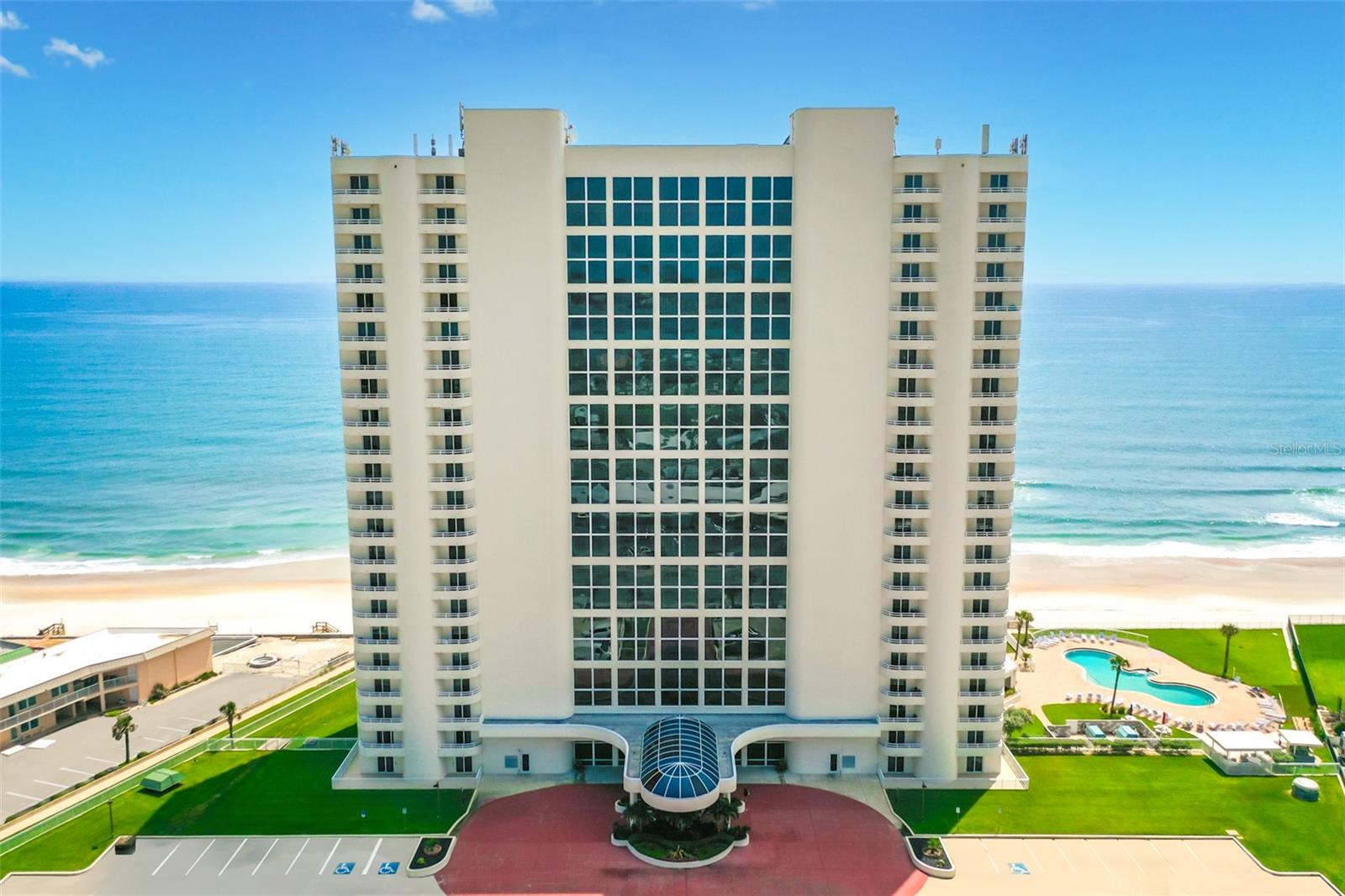 THE OCEANFRONT ICON WHERE THE 21 STORY GRAND LOBBY DEBUTS A SPA-LIKE WELCOME WITH WATER CASCADING DOWN A VERTICAL WALL INTO A POLISHED ROCK BED AND FLOWING WATER OFFERS SOOTHING SOUNDS AND VISUAL APPEAL. CURVED BALCONIES ARE A WORK OF ART. PREPARE TO BE AMAZED BY THE OCEANFRONT EXPANSE THIS CONDOMINIUM HOME EXHIBITS. RICHLY APPOINTED & DELIVERED FULLY FURNISHED! THE OCEANFRONT GREAT ROOM IS THE PERFECT SPACE TO RELAX AND ENTERTAIN. BOTH COMFORTABLE AND INVITING, THE SPACE FLOWS ONTO THE PRIVATE OCEANFRONT BALCONY THROUGH NEW SLIDING GLASS DOORS. THE CHEF INSPIRED KITCHEN FEATURES ABUNDANT CABINETRY AND SUBSTANTIAL GRANITE COUNTERS AND BAR. PASSIONATE FOODIES AND CASUAL GOURMETS WILL LOVE THIS KITCHEN! THE GRAND PRIMARY SUITE SERVES AS A PRIVATE SANCTUARY, FEATURING A SITTING AREA, A CUSTOM, SERENE BATH THAT ENGULFS YOU IN A WORLD OF LUXURY. A SECONDARY ENSUITE OWNER'S BEDROOM IS ALSO OCEANFRONT AND EQUALLY PRIVATE. INDOOR/OUTDOOR POOLS SET THE TONE FOR SPECTACULAR FLORIDA LIVING. THIS RICHLY APPOINTED FLOOR PLAN FLOWS SEAMLESSLY TO SWEEPING OCEAN VIEWS FROM EVERY VANTAGE POINT, BLENDING SUPERIOR COASTAL LIVING IN ONE OF DAYTONA BEACH SHORES' MOST COVETED COMMUNITIES. THE REMODELED PENTHOUSE CLUB ROOM IS WIDELY REGARDED AS THE BEST ON THE BEACH! ADDITIONAL COMFORTS INCLUDE ON-SITE MANAGEMENT AND GENEROUS PARKING ARE RARE TANGIBLE ASSETS TENDERED HERE. THIS CONDOMINIUM ESTATE IS FOR EVERYONE THAT VALUES ARTISTRY AND ENDURING PRESTIGE.