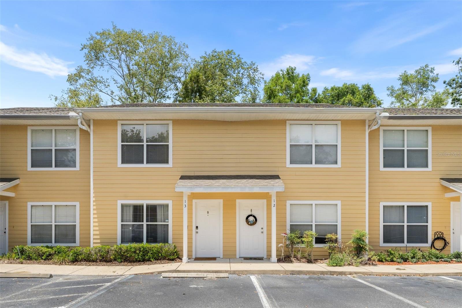 Location, Location! Move-In Ready! Beautifully updated condo in the highly sought-after Isabella Park community, conveniently located less than 1.5 miles from the University of Florida and Shands Hospital.  This 2-bedroom, 2.5-bath condo features a bright, spacious living room that flows into a beautifully updated eat-in kitchen with abundant storage, newer stainless steel appliances, and an oversized sink. Luxury vinyl plank flooring runs throughout the home—no carpet! A convenient half bath is located on the main floor for guests. Upstairs, each bedroom offers its own updated en-suite bathroom and double closets. Both bathtubs have been converted into beautifully tiled walk-in showers, and the bathrooms feature new toilets, modern vanities, and quartz countertops. Relax year-round on the screened, covered porch—the perfect spot to enjoy your morning coffee or unwind after a long day. Additional updates include a newer water heater and an HVAC system that has been professionally maintained every six months. The condo is conveniently located near multiple bus routes, making commuting simple and hassle-free. The Isabella Park community is small, well maintained, and features a newer roof. Furniture is negotiable. Don't miss this exceptional opportunity! **Ring camera wired and comes with property. Also includes keyless kwikset entry.