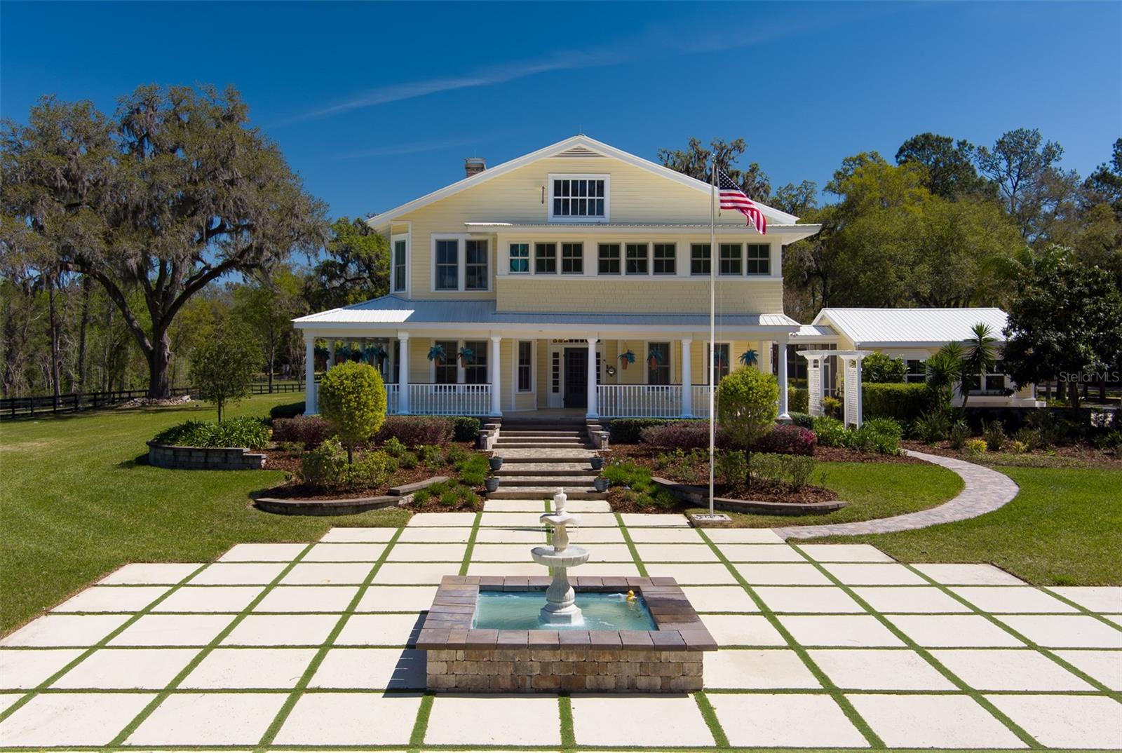 This stunning 23.06-acre farm, located just 20 minutes from the World Equestrian Center, offers an unparalleled blend of luxurious living and equestrian amenities. The property features 8 well-maintained paddocks, a round pen, and a spacious 80x200 covered arena, perfect for training and riding. The 8-stall center-aisle barn includes a 1-bedroom, 1-bathroom apartment, providing comfortable living quarters for staff or guests. The barn is well-equipped with a bathroom, feed room, tack room, and wash racks. Additionally, an outbuilding with four built-in kennels is ideal for dog lovers. The main house, a beautifully renovated home built in 1918, is a two-story traditional country residence with 5 bedrooms, 5 full bathrooms, and 1 half bathroom. Large windows, high ceilings, and expansive sunrooms bring in natural light, while multiple fireplaces, including one in the master en suite bath, create a cozy, welcoming atmosphere. Attached to the home is a 2-car garage, offering added convenience and storage space. Outside, you'll find a stunning pool with a spa, a spacious outdoor kitchen/grill area, a tennis court, and a koi pond, surrounded by breathtaking landscaping. This property offers a unique opportunity to enjoy both a luxurious lifestyle and world-class equestrian facilities, making it the perfect sanctuary for horse enthusiasts and nature lovers alike.