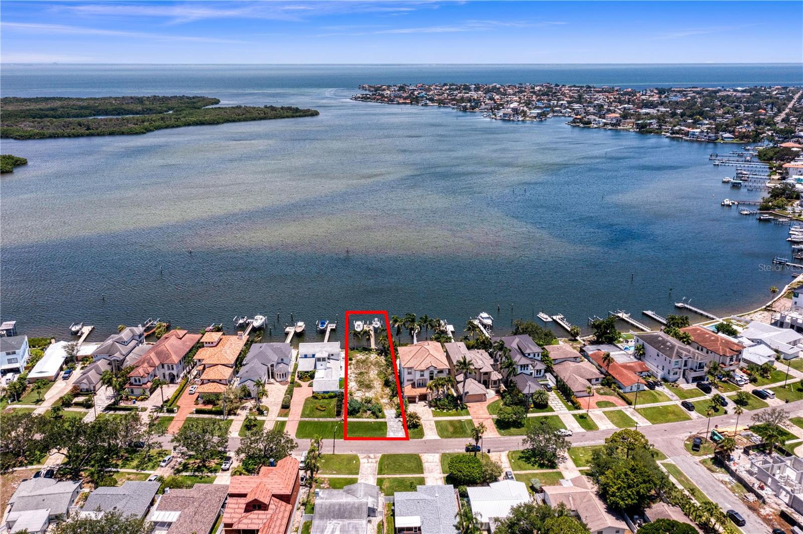 Enjoy spectacular open water views and direct access to Tampa Bay with no fixed bridges from this exceptional waterfront homesite in one of Northeast St. Petersburg’s most sought after boating communities. With 50 feet of waterfront frontage and approximately 8,925 square feet of land, this rare property offers sweeping views across Tampa Bay to Weedon Island Preserve, creating the perfect setting for a custom luxury waterfront residence.

Surrounded by newly constructed estate homes, the property is ideally positioned within a neighborhood experiencing significant luxury redevelopment. As an added bonus, custom home plans specifically designed for the site will convey with the sale, providing a valuable head start toward building your dream home.

Boating enthusiasts will appreciate the unrestricted access to Tampa Bay and beyond, while existing waterfront improvements include a dock resurfaced with composite decking in 2018 and two boat lifts, including a 16,000 pound lift installed in 2018 and an additional 6,000 pound lift. 

Wake up to breathtaking sunrises, enjoy frequent dolphin and wildlife sightings, and embrace the waterfront lifestyle from your future backyard. Conveniently located near downtown St. Petersburg, waterfront parks, walking and biking trails, and vibrant dining and entertainment destinations, this property offers a rare opportunity to build a custom waterfront estate in one of the city’s premier locations.

Experience the very best of Florida waterfront living with panoramic bay views, exceptional boating access, and endless possibilities for creating a one of a kind coastal retreat.