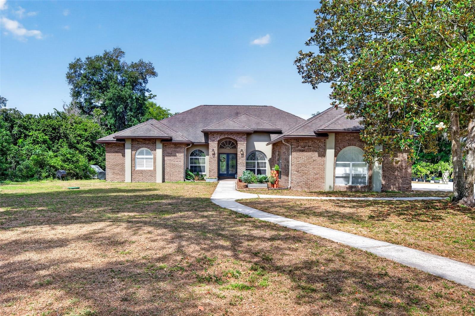 Welcome to country living just 20 minutes from the vibrant Tampa area! This beautifully remodeled 4-bedroom home offers the perfect blend of space, comfort, and modern updates. Situated on nearly 2 acres in the Stafford Oaks neighborhood in Plant City with no HOA, this property provides room to spread out and enjoy a more relaxed lifestyle. Inside, you’ll find a recently remodeled kitchen and spacious primary bath.  The flooring has also been updated to wood plank porcelain tile. Outside, the property is ready for your homesteading dreams with a chicken coop and established garden setup. Don’t miss this must-see opportunity to enjoy peaceful country living with convenient access to the city!
NEW ROOF installed May 2026 newer AC