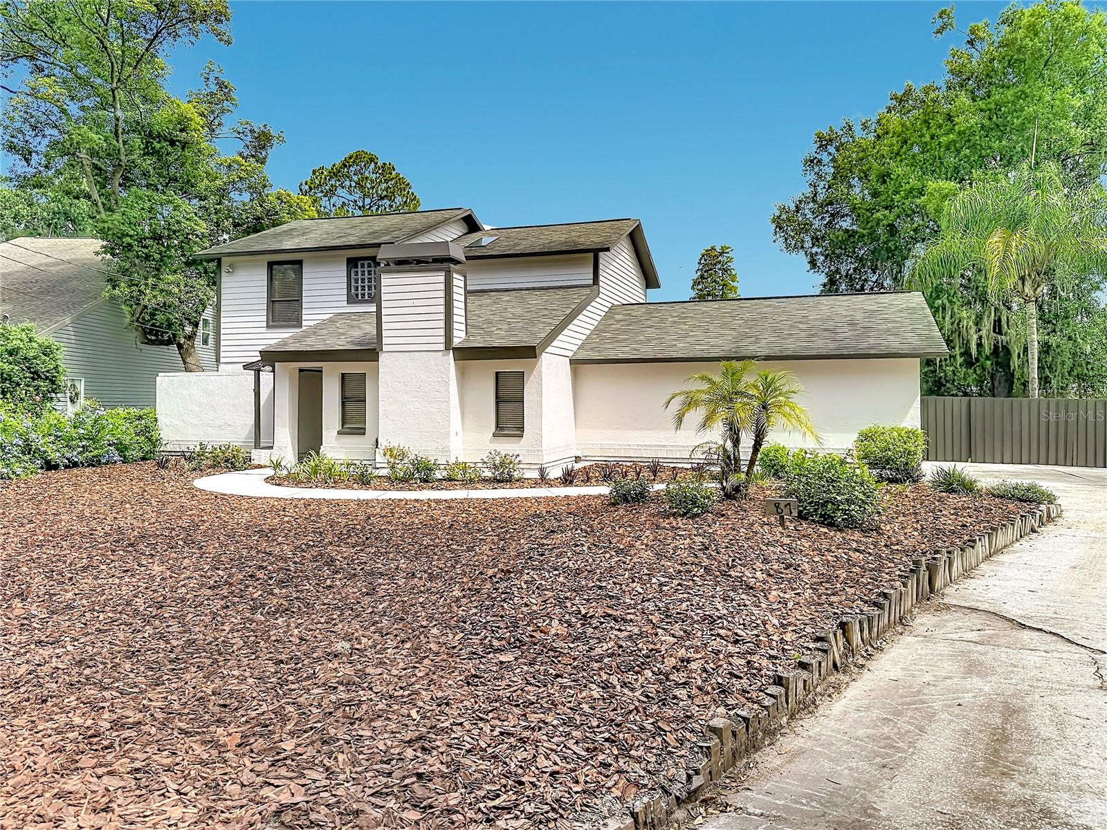 Welcome to lakefront living in the heart of Lutz! Tucked away at the end of a quiet dead-end street, this charming 3-bedroom, 2.5-bath home sits on a private .59-acre lot overlooking beautiful Lutz Lake. Offering 1,801 square feet of living space, the home features soaring ceilings, a sunken living room with a wood-burning fireplace, an updated kitchen with granite countertops, wood cabinetry, a walk-in pantry, and a spacious loft. The first-floor primary suite includes private access to the screened lanai and an updated ensuite bath with dual vanities, a large tiled shower, and abundant closet space. Upstairs, you'll find two generously sized bedrooms, a full bath, and a versatile loft area. Step outside to enjoy the park-like backyard with direct lake access, perfect for kayaking, canoeing, fishing, or simply relaxing and taking in the views. Recent updates include exterior painting 2025, new water softener system 2025, roof (2019), HVAC (2014), water heater (2014), flooring (2014), French doors (2012), and remodeled bathrooms. Located in the highly sought-after Steinbrenner High School district with no HOA or CDD fees, and convenient access to US-41, I-275, the Suncoast Parkway, shopping, dining, and entertainment. Rarely does a lakefront property in downtown Lutz become available, schedule your private showing today.