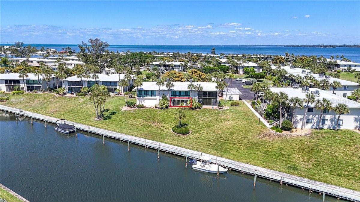 Welcome to an inviting ground-level canal-front condo tucked into the highly sought-after WestBay Point and Moorings community on beautiful Anna Maria Island. This bright and airy 2-bedroom, 2-bath residence welcomes you with a private front courtyard—an ideal spot for morning coffee or a quiet read—then leads into a versatile enclosed lanai offering endless possibilities for a home office, sunroom, or additional entertaining space. Inside, the updated kitchen features KraftMaid cabinets, and new countertops, convenient pull-out drawers and a wet bar that make hosting effortless. The expansive dining and living room combination brings in natural light from multiple sliders and flows seamlessly to the enclosed back lanai, where peaceful canal views and glimpses of the community tennis courts set a serene backdrop. The primary suite is a tranquil retreat with lanai access, an updated ensuite bathroom and generous walk-in closet with abundant storage. The beautifully updated second bath serves the guest bedroom, which also enjoys direct access to the front lanai, plus its own walk-in closet. This ground-floor unit is especially attractive for its accessibility and, importantly, it did not flood. Beyond the home, WestBay Point and Moorings deliver resort-style amenities: a heated community pool and spa, well-maintained tennis courts, and a kayak launch for easy access to the canal and surrounding waterways. Nestled in the heart of Holmes Beach, the community offers a rare combination of convenience and privacy—close to shops, dining and the island’s renowned beaches, yet tucked away for peaceful, everyday living. This thoughtfully updated condo is a must-see for anyone seeking island living with comfort, storage and outdoor lifestyle conveniences. Short walk to restaurants, shops, and Island trolly stop.