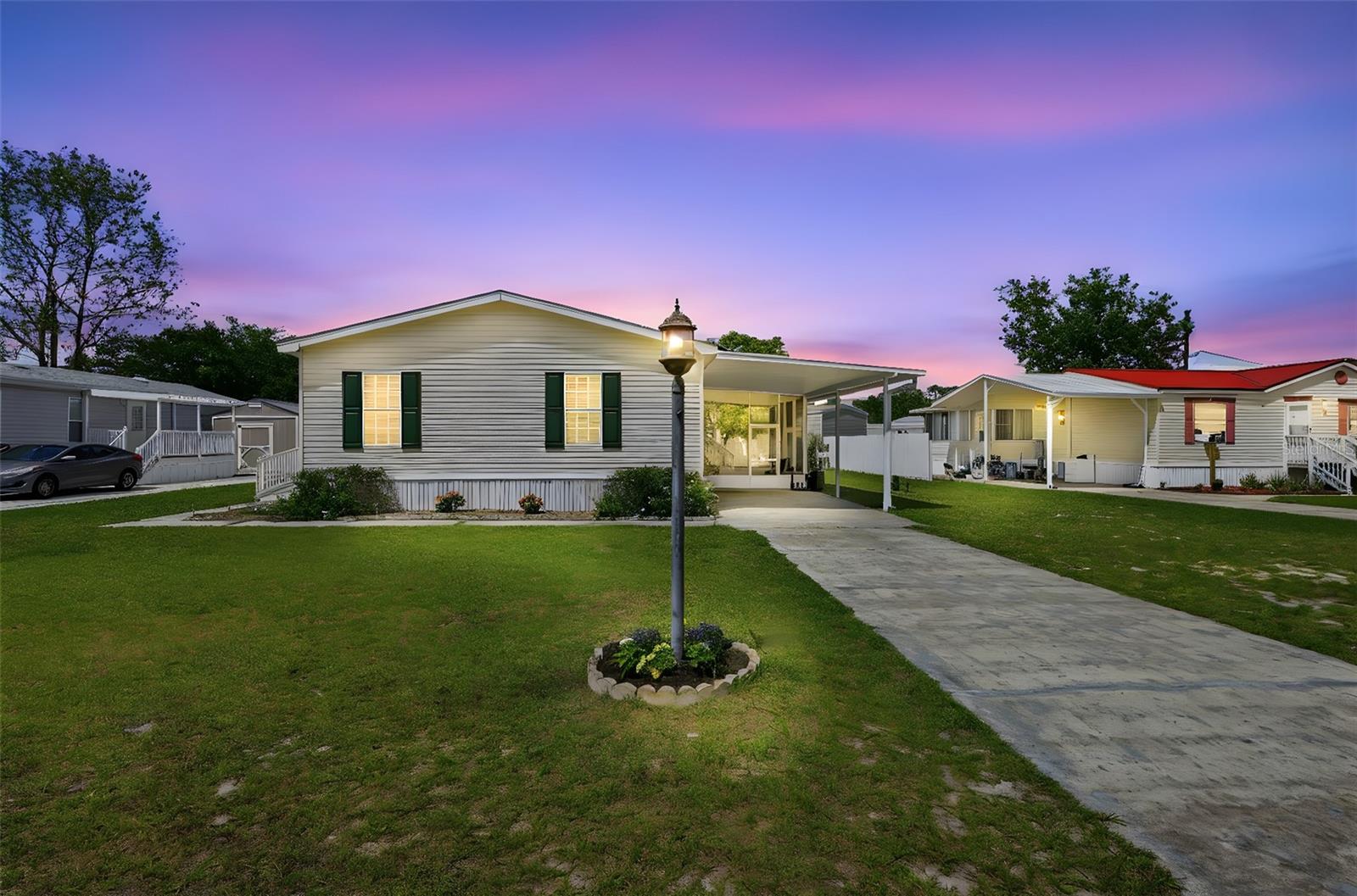 NO HOA-NO LOT RENT! Amazing Snowbird Retreat! Pride of ownership shines in this well-maintained, like-new manufactured home—gently lived in only six months out of the year. Major update includes a roof replaced in 11/2019.
Step inside to a light and bright interior featuring upgraded luxury vinyl plank flooring in the main living areas and primary bedroom. All rooms are equipped with ceiling fans and upgraded blinds for added comfort and style.
The spacious primary suite offers a walk-in closet and a large ensuite bathroom complete with double sinks, a stand-up shower, featuring an upgraded commode, and an oversized linen closet with ample storage. The desirable split floor plan provides privacy, with the secondary bedrooms and guest bath located on the opposite side of the home.
The open-concept kitchen overlooks the dining and living areas and includes white cabinetry with crown molding, a breakfast bar, and an upgraded Bosch dishwasher. All appliances convey, including the washer and dryer.
Exterior features include a front ramp for easy accessibility, a covered carport, and a large screened porch—perfect for relaxing. The backyard offers additional space to enjoy, complete with a large shed and partial fencing.
Bonus: This home can be sold fully furnished—just bring your clothes and start enjoying your Florida retreat right away!
Energy Efficiency: Home is equipped with leased solar panels, helping to offset utility costs. Buyer to assume lease (details available).
Move-in ready and ideal for seasonal or year-round living!