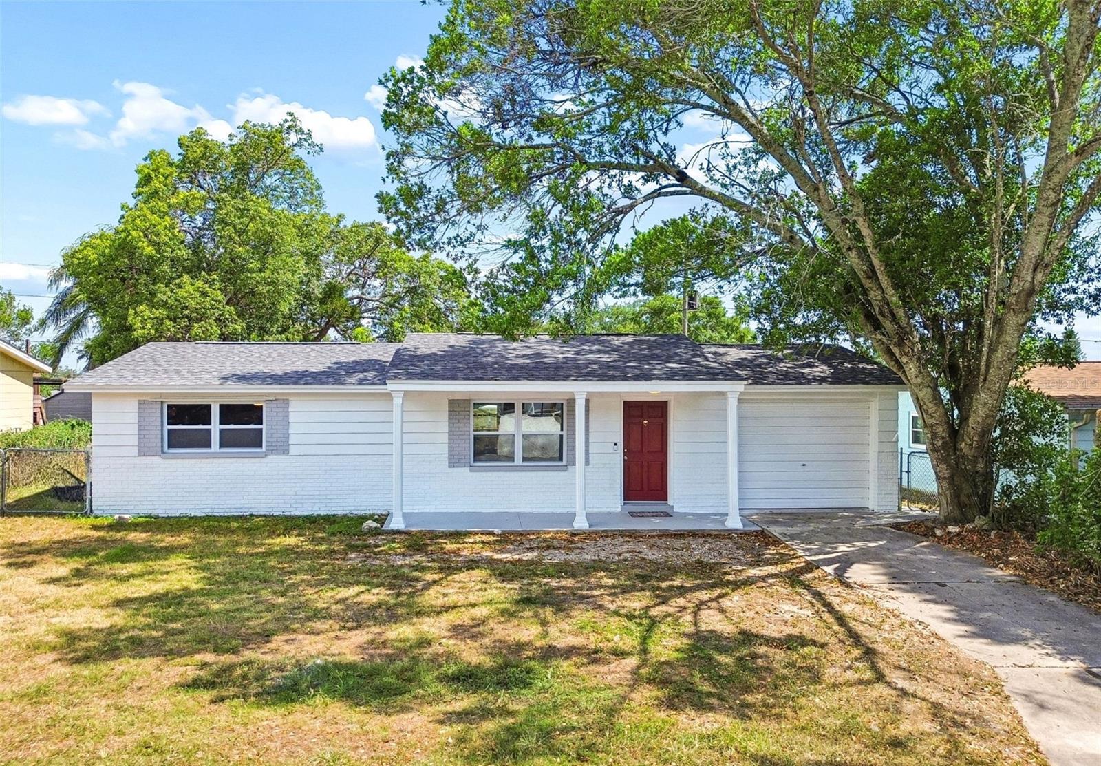 Virtually Staged. Welcome to 5046 Farley Drive, where you can simply move in and enjoy! This charming concrete block home has been beautifully renovated and is in exceptional condition, offering peace of mind from the moment you walk through the door.  Best of all, there are no HOA fees, no deed restrictions, and the home is not in a flood zone, giving you more freedom and fewer expenses.  As you pull in the driveway you'll love the curb appeal, with the crisp white paint, red front door and the welcoming front porch. Step inside you'll find 2 bedrooms, a beautifully updated bathroom, and an inviting, open layout with a breakfast bar that flows into the stunning new kitchen. There's also a versatile flex room overlooking the backyard that can easily serve as a dining room, home office or hobby room.  Recent updates include: gorgeous wood-look tile flooring throughout the entire home, Brand-new kitchen with white cabinetry, new countertops and a stainless-steel sink with the coolest rain-style faucet in town!  Completely renovated bathroom, even the bathtub is brand new and wait until you see the pretty sink. New hot water heater, New energy-efficient windows, New interior doors, New ceiling fans with remote control in every room, LED lighting throughout, New Ring doorbell, Fresh interior and exterior paint, New roof (2023) and AC (2019).  See what I mean...all you have to do is move in and start enjoying life!  And don't forget to step outside to enjoy the cozy screened lanai, the perfect spot to sip your morning coffee or relax & unwind in the evening. The fully fenced backyard offers plenty of room for pets, gardening or sitting around the firepit in the evening- there's even enough room to add a pool back here!  There's also an oversized one-car garage, with room for your car and extra space for storage, including the washer & dryer.  This pretty home is located in a super convenient neighborhood close to shopping, restaurants, great schools, parks, downtown New Port Richey, Tarpons Springs sponge docks and the award-winning Gulf Coast beaches.  Don't miss this amazing home, give me a call to see it today.