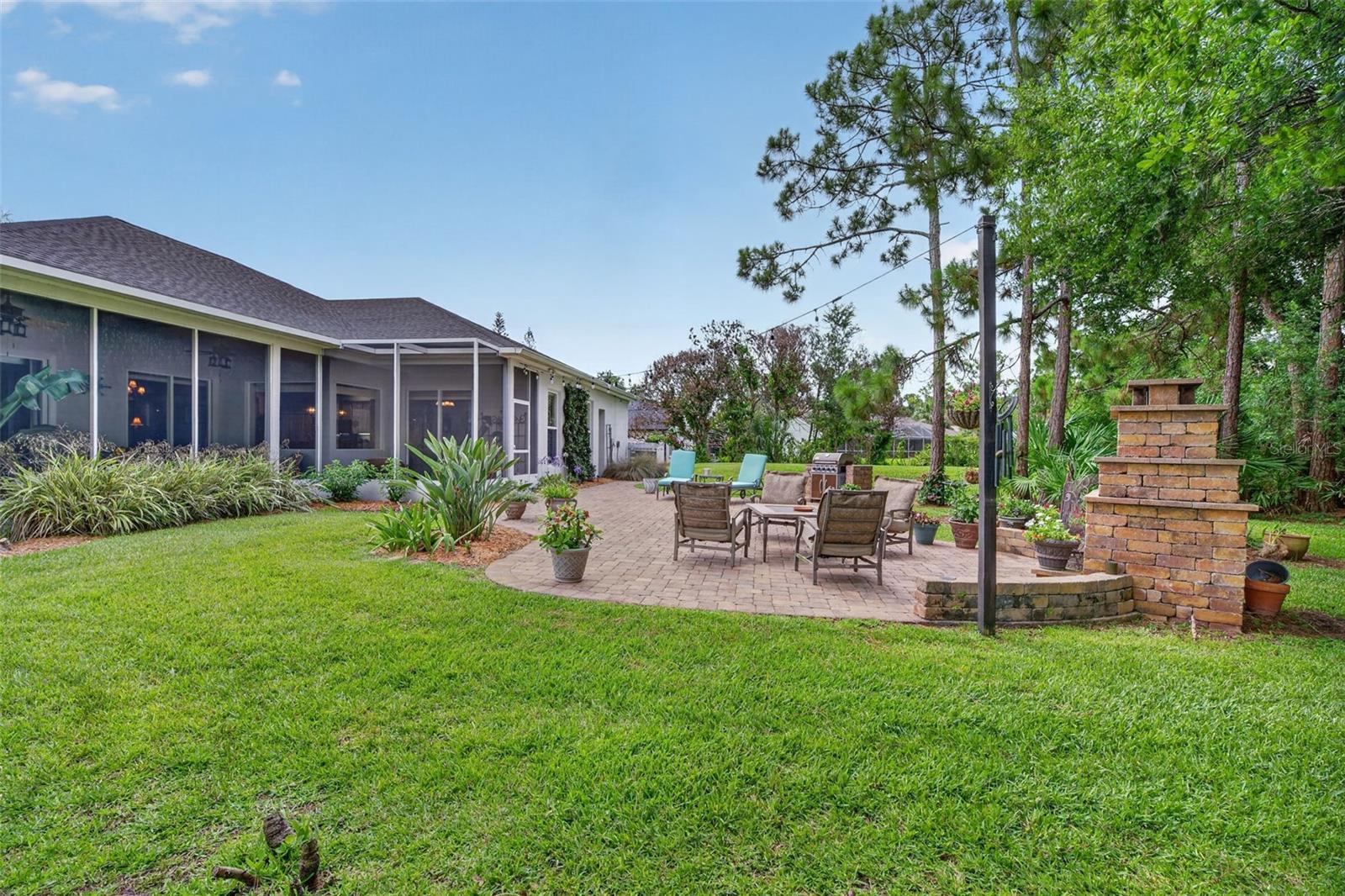 Welcome to 3650 Meadowlark Way, a stunning custom-built home located in the highly desirable Carriage Gate community of Melbourne. Situated on an expansive half-acre lot, this exceptional property offers the perfect combination of privacy, space, and elegant living, surrounded by mature landscaping and a tranquil wooded backdrop.

Step inside and be greeted by dramatic 12 ft. ceilings as well as elegant wood look flooring throughout the entire home (no carpet) and an open, airy floor plan designed for both comfortable everyday living and effortless entertaining. The spacious formal living and dining rooms provide an elegant setting for gatherings, while large windows fill the home with natural light.

The well-appointed kitchen is the heart of the home, featuring beautiful 42-inch white cabinetry with crown molding, high end granite surfaces with custom designed backsplash, stainless steel appliances, a convenient breakfast bar, pantry, and a sunny breakfast nook perfect for casual dining. The open layout seamlessly connects the kitchen to the main living areas, creating an inviting atmosphere for family and friends.

Retreat to the spacious primary suite, complete with sliding glass doors overlooking the private wooded setting. The luxurious primary bathroom offers dual vanities, separate his-and-her closets, a tiled walk-in shower, and a relaxing soaking tub, creating a true owner's retreat.

With four additional bedrooms, this home provides plenty of flexible space for family, guests, home offices, fitness rooms, or hobbies. The thoughtful layout offers room for everyone while maintaining privacy and comfort throughout.

Step outside to the screened porch, outdoor paver patio with custom built fireplace and enjoy peaceful mornings or relaxing evenings overlooking the large backyard and serene wooded surroundings. The oversized half-acre lot provides ample space for outdoor activities, gardening, or future customization while maintaining exceptional privacy.
Additional features include a spacious three-car garage, abundant storage, and a low HOA fee of approximately $50 per month, new a/c 2020, new roof 2023, new irrigation pump 2024.

Conveniently located near top-rated schools, shopping, dining, parks, golf courses, and major roadways, this home offers easy access to everything Melbourne and Florida's Space Coast have to offer. Nearby activities include beautiful Atlantic beaches, boating, fishing, kayaking, nature preserves, Brevard Zoo, championship golf courses, and the area's renowned aerospace and technology corridor.

Don't miss this rare opportunity to own a custom-built home on a private half-acre lot in one of Melbourne's most desirable communities. Schedule your private showing today!