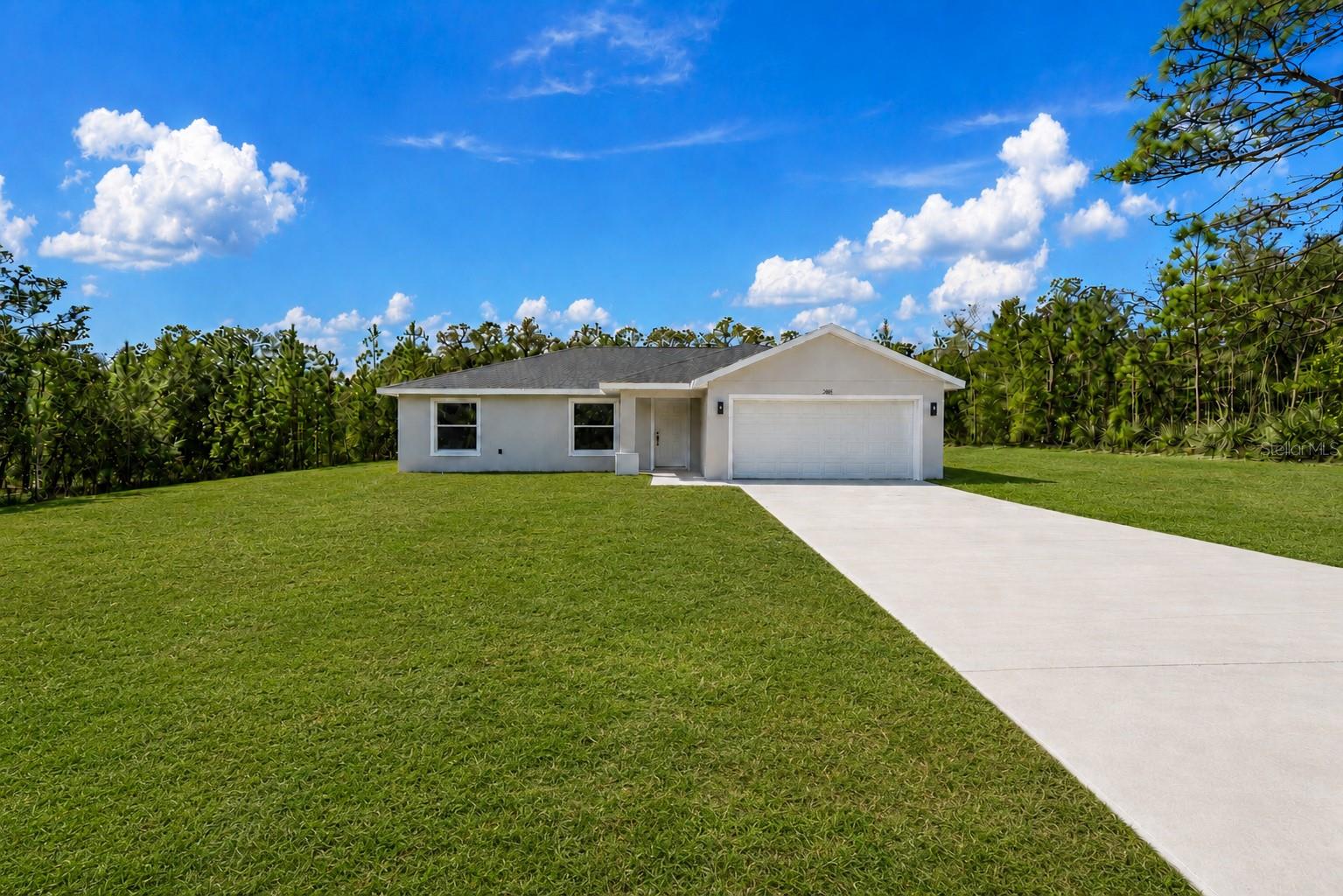 Welcome home to the perfect blend of modern comfort and peaceful country living. Nestled on a private 1-acre homesite, this beautifully finished home offers the space, quality, and freedom you've been looking for—without the restrictions of an HOA. Step inside and you'll immediately appreciate the bright, open floor plan, soaring vaulted ceilings, and beautiful luxury vinyl plank flooring that flows seamlessly throughout this split plan 3 bedroom 2 bath home. The heart of the home is the stunning kitchen, thoughtfully designed with granite countertops, white shaker soft-close cabinetry, stainless steel appliances, and plenty of workspace for cooking, gathering, and making memories. The spacious primary suite is a relaxing retreat featuring a large walk-in closet and a beautifully appointed bath with a tiled walk-in shower and glass enclosure. The guest bathroom is equally impressive with a porcelain soaking tub surrounded by designer tile, creating a fresh, upscale feel throughout. An inside laundry room adds everyday convenience and extra storage. Step outside and enjoy what makes this property truly special. With a full acre to call your own, there's room to garden, watch the wildlife, enjoy morning coffee on the porch, or simply relax and take in the quiet surroundings. Whether it's birds visiting the yard, deer wandering nearby, or peaceful evenings under the stars, this is the kind of setting that's becoming harder to find. Located just minutes from Rainbow Springs State Park, you'll have endless opportunities for kayaking, tubing, swimming, fishing, hiking, and enjoying Florida's natural beauty. The nearby Rainbow Lakes Community Center offers tennis courts, basketball, racquetball, baseball fields, and a playground, providing recreation for all ages. Downtown Dunnellon is just a short drive away for shopping, dining, and everyday conveniences. If you've been searching for an affordable home that combines beautiful finishes, modern design, a spacious homesite, and a peaceful lifestyle close to nature, this home deserves a place at the top of your list. Owner financing is available.