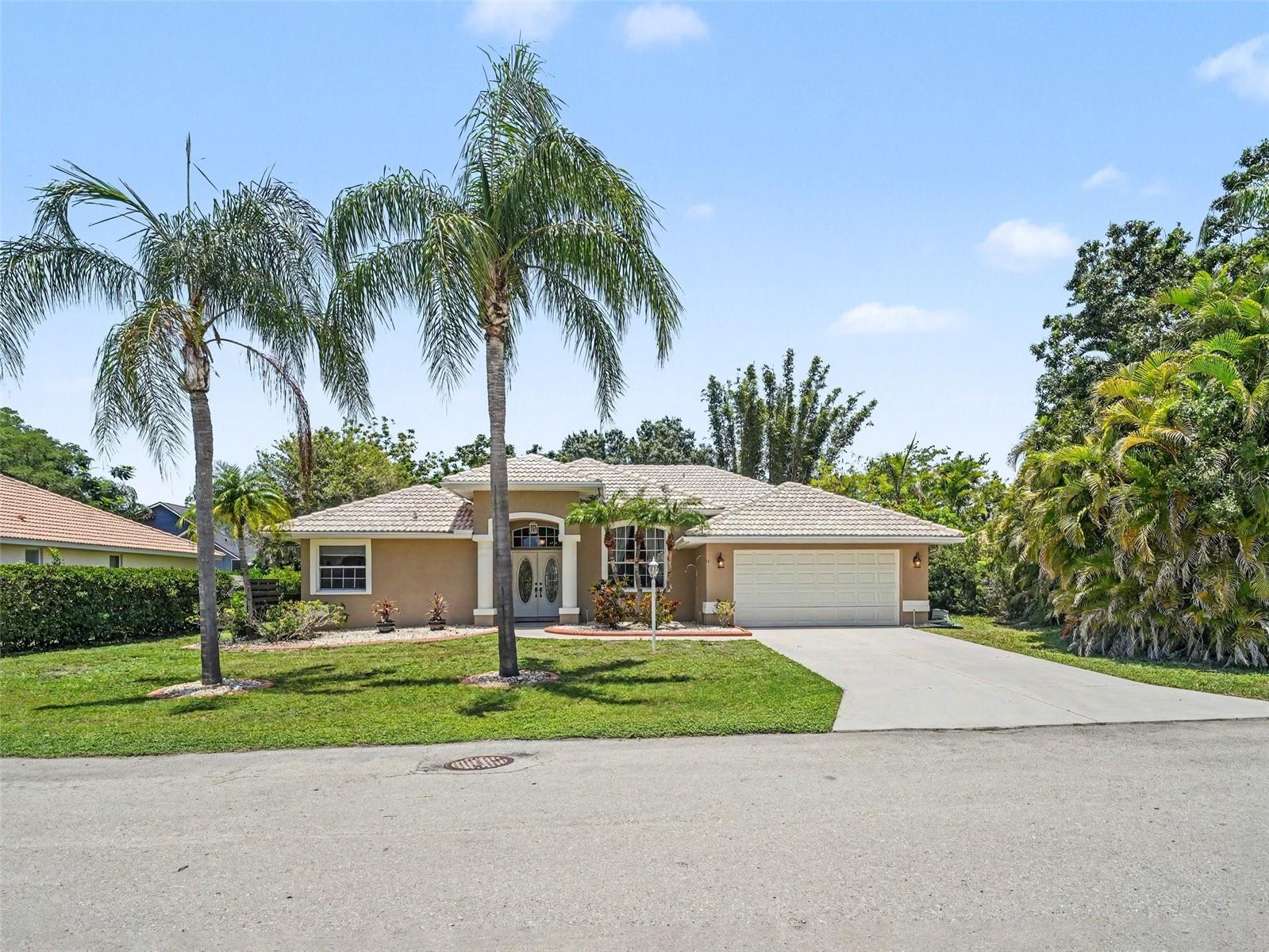 This home is a must see! Fantastic opportunity to own this 3-bedroom, 2-bath home located in a small enclave of just 11 custom built homes on over-sized lots, in the heart of Sarasota. Entering this lovely home reveals a thoughtfully designed, large open floor plan with well-appointed upgrades. Soaring ceilings give the home a feeling of grandeur. An Archway leads you from the formal living room and dining room to the kitchen and informal living room. The kitchen opens to a large living space with windows and glass doors allowing natural light to fill the home. Sliding doors lead out to the covered lanai and extended caged patio overlooking a large backyard. There is ample room to add a pool. The master suite is spacious with a huge walk-in closet, marble soaker tub, double marble sink and powder room and a sizeable walk-in shower. The split floor plan offers privacy with the additional bedrooms located on the opposite end from the owner's suite. The home's solid construction ensures peace and quiet both inside and out. New ductwork and 15 inches of attic insulation will keep your electric bill low. Crown molding, pocket doors, and so much more. Located in a highly sought after school district and central to Sarasota's beaches, downtown, dining and the arts. Come make this home your own!