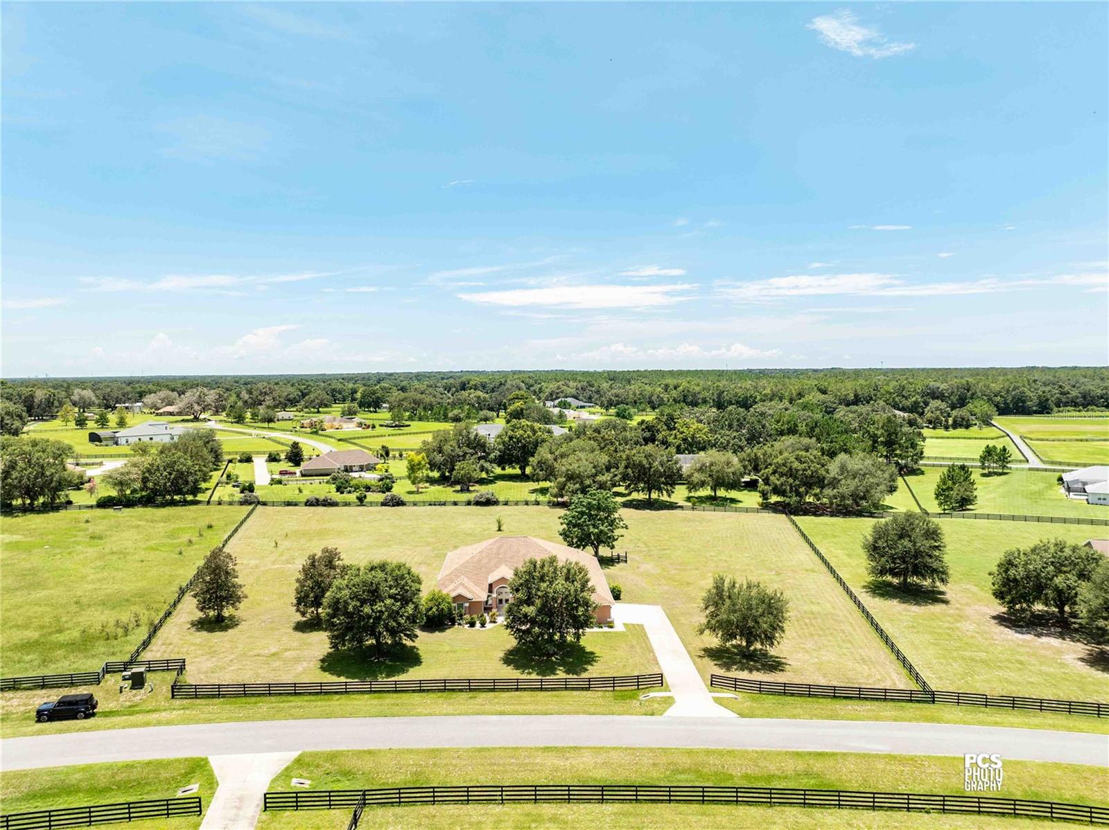 Nestled on a serene 2.55-acre lot within the gated enclave of Sumter Crossing, this 4-bedroom, 2½-bath home seamlessly combines elegance with the tranquility of spacious country living. As you pass through the private gated entrance, you’ll immediately feel the upscale ambiance and peaceful charm of the neighborhood. Inside, the home features an open-concept layout with soaring ceilings, expansive windows, and durable tile flooring, creating a bright and inviting flow between the living, dining, and kitchen areas—ideal for both relaxing and entertaining.The chef’s kitchen is a highlight, offering abundant storage with custom cabinetry, sleek granite countertops, and high-end stainless steel appliances, including a double oven—perfect for preparing meals, whether for intimate gatherings or large family celebrations.The primary ensuite is a true retreat, featuring a sliding glass door that opens directly to the back patio, offering seamless access to outdoor living. The luxurious bathroom is designed with dual vanities, a beautifully tiled shower, and a soothing soaker tub, transforming the space into a spa-like sanctuary. A spacious walk-in closet ensures ample storage for all your wardrobe essentials.Each of the four generously sized bedrooms provides comfort and privacy, while the 2½ baths combine style and practicality. Outside, the fully fenced yard offers both privacy and security, creating a perfect setting for pets or peaceful relaxation. The two-car garage provides plenty of parking, while the additional golf cart garage offers extra space for storage or recreational vehicles.